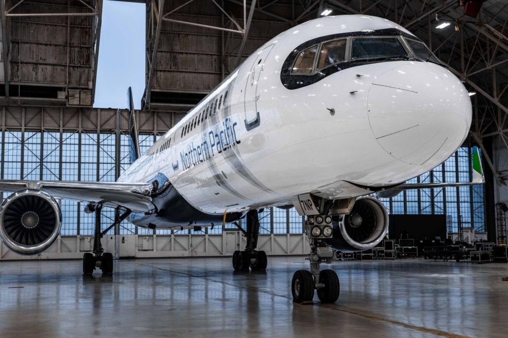 A Northern Pacific Airways Boeing 757 parked in a hangar.