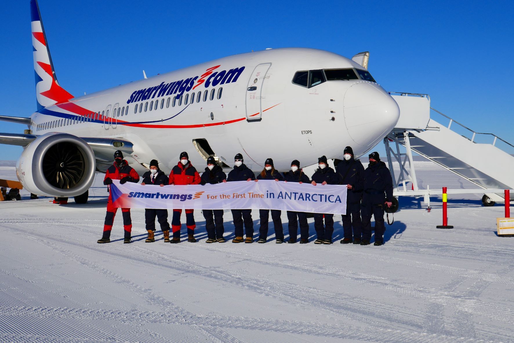 Several Smartwings employees in front of a Boeing 737 MAX in Antarctica.
