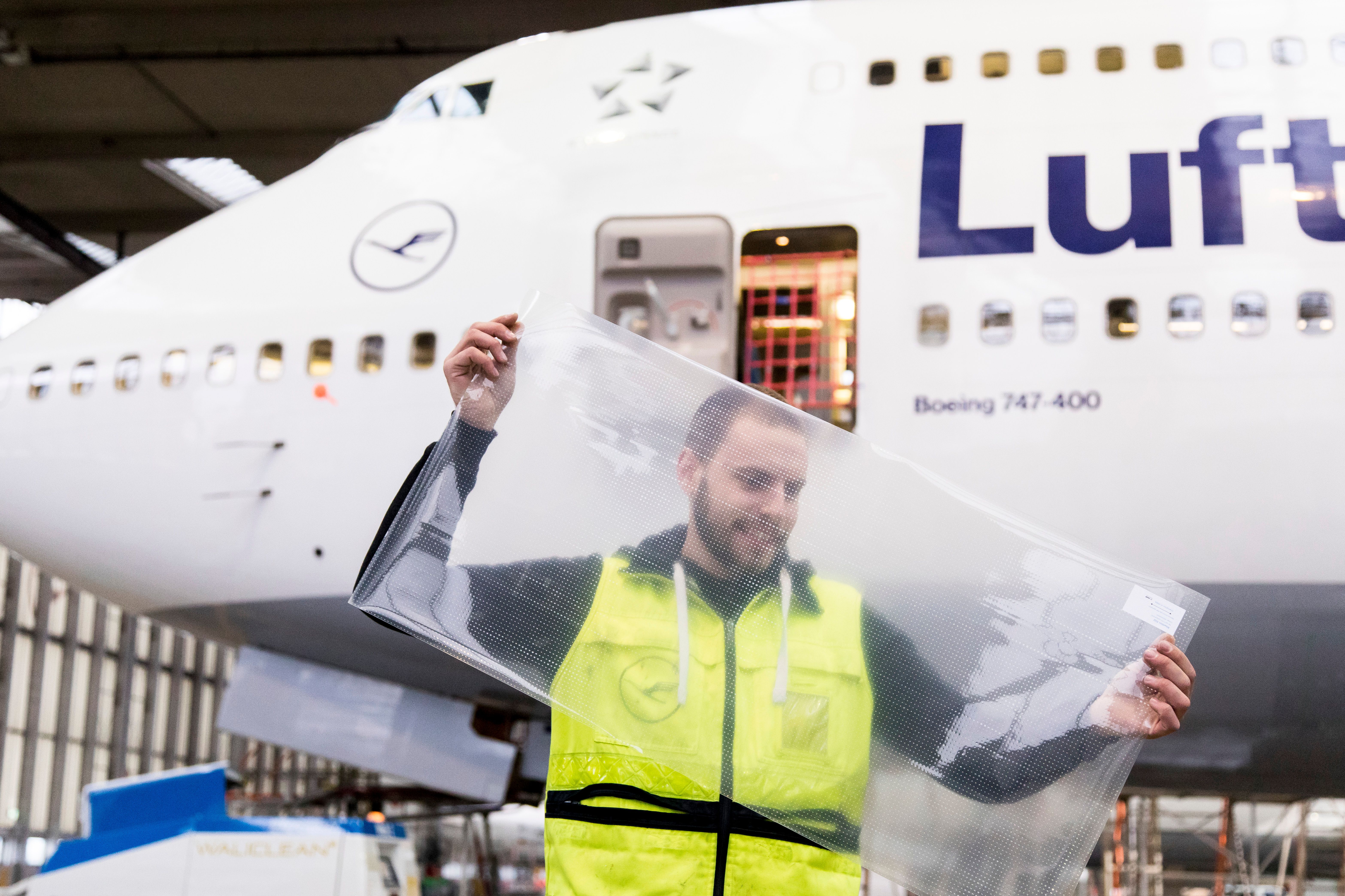 An engineer standing near a Lufthansa Boeing 747.