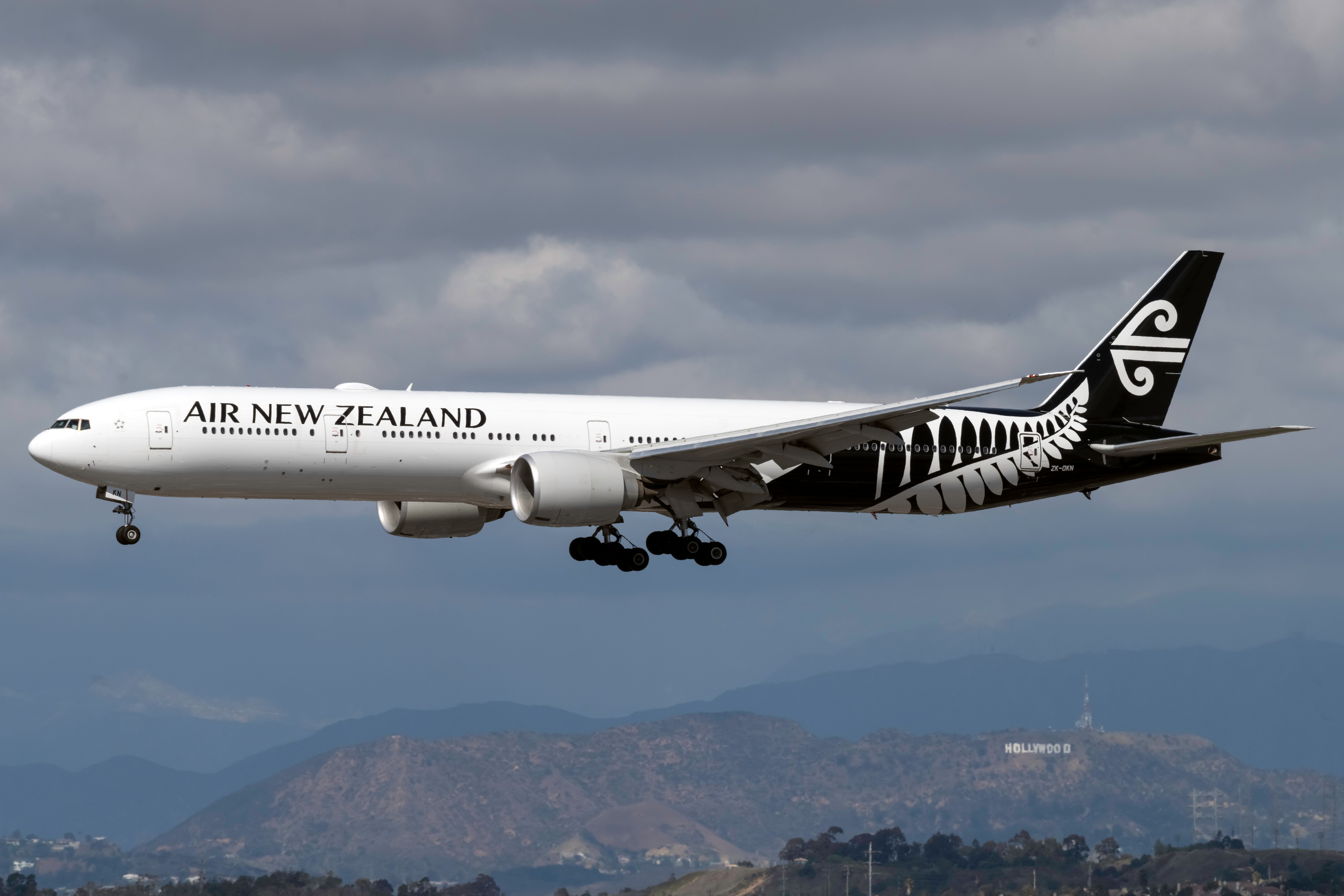 Air New Zealand Boeing 777-319 landing against cloudy sky