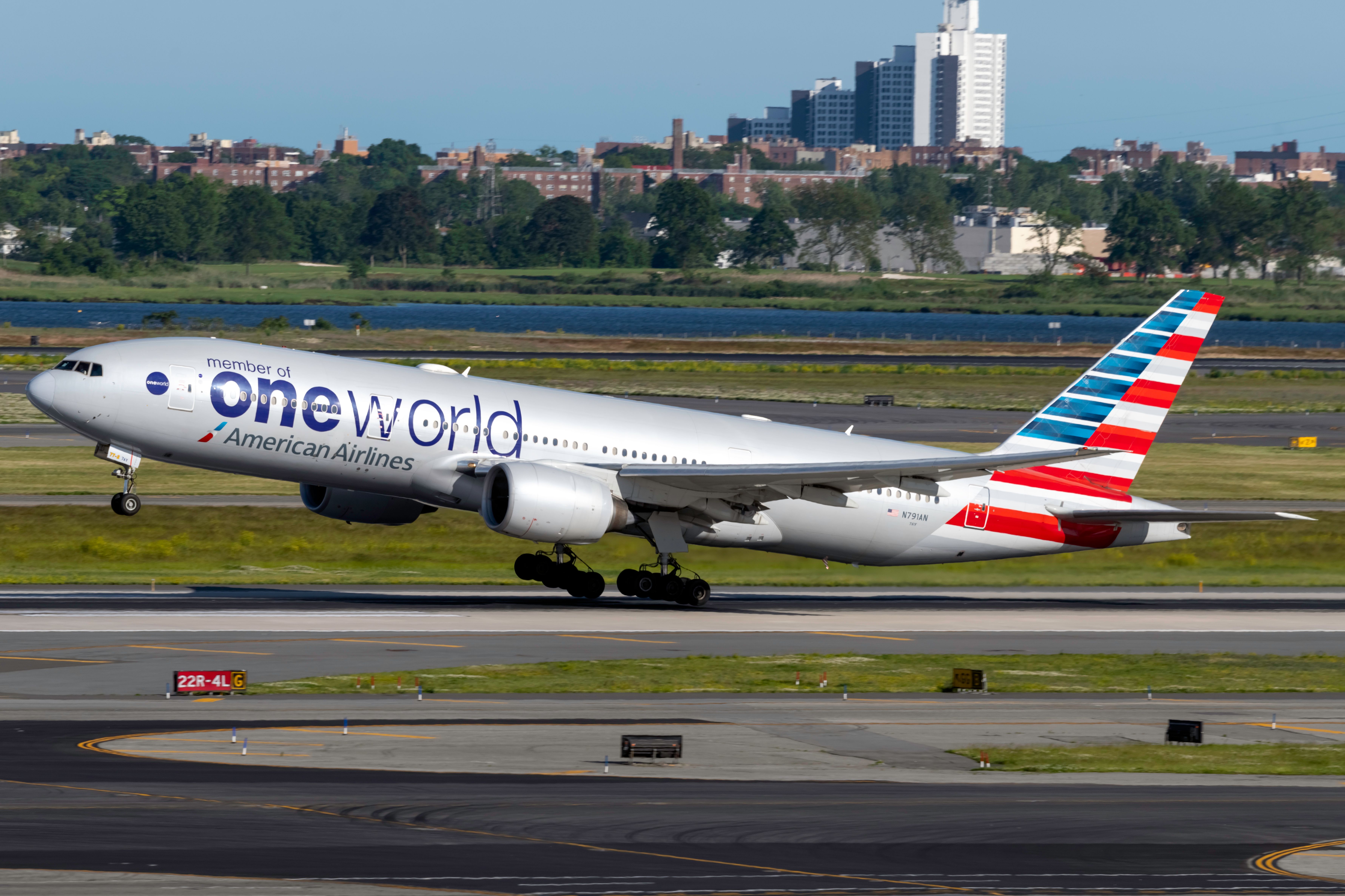 An American Airlines Boeing 777 in Oneworld Livery taking off.