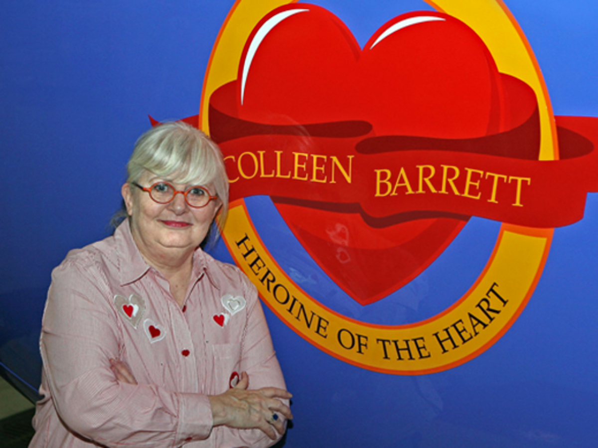 Southwest Airlines President Emeritus Colleen Barrett in front of Heroine of the Heart sign