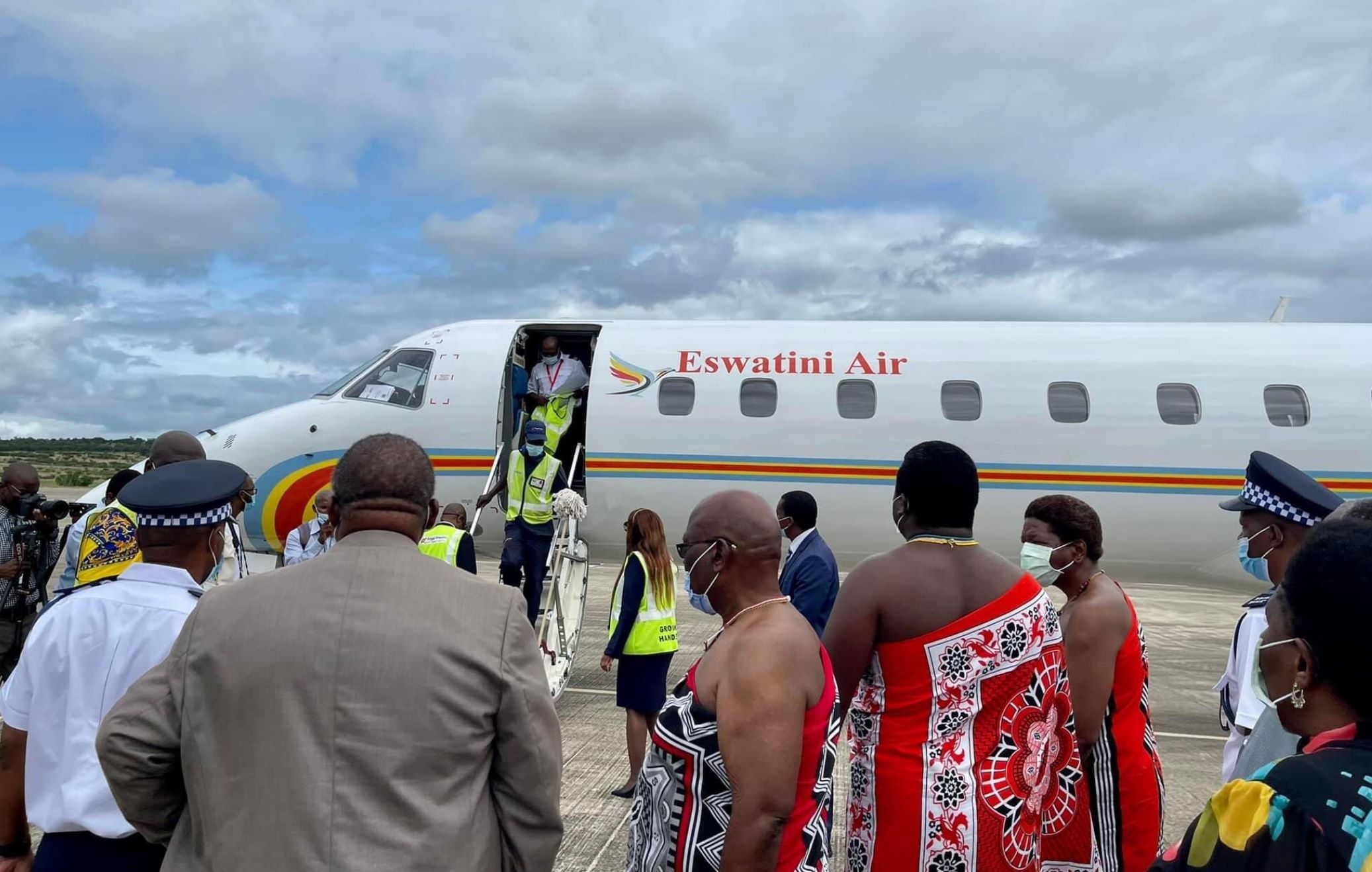 An Eswatini Air Embraer ERJ-145 parked as passengers disembark.