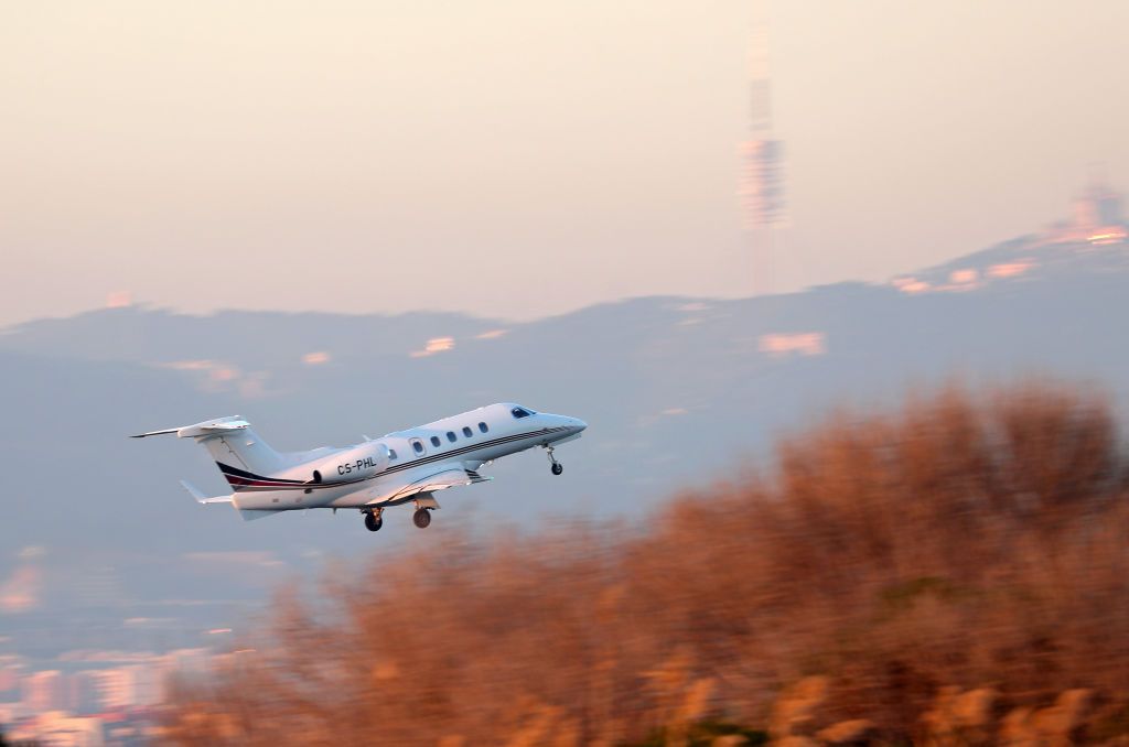 An Embraer Phenom 300 just after take off.