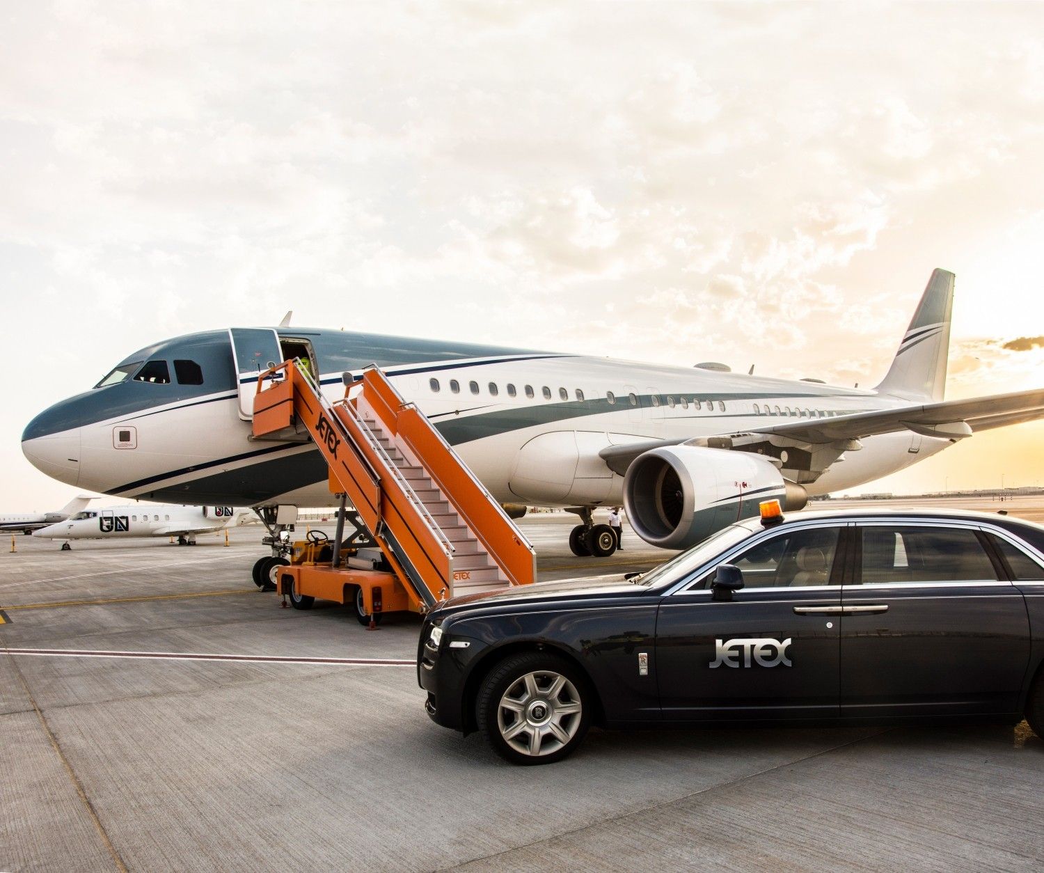 A Jetex vehicle bringing passengers to a large private jet.