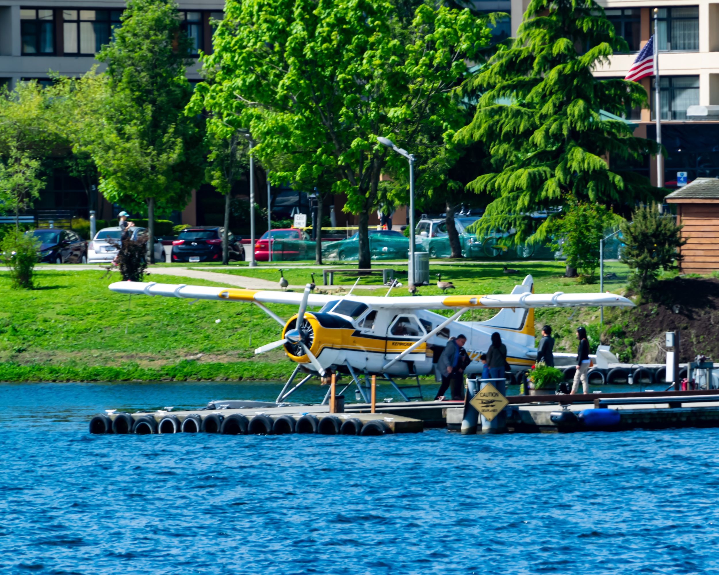 Passengers Boarding A Kenmore Air DHC-2 Beaver From A Waterways Cruise on Lake Union