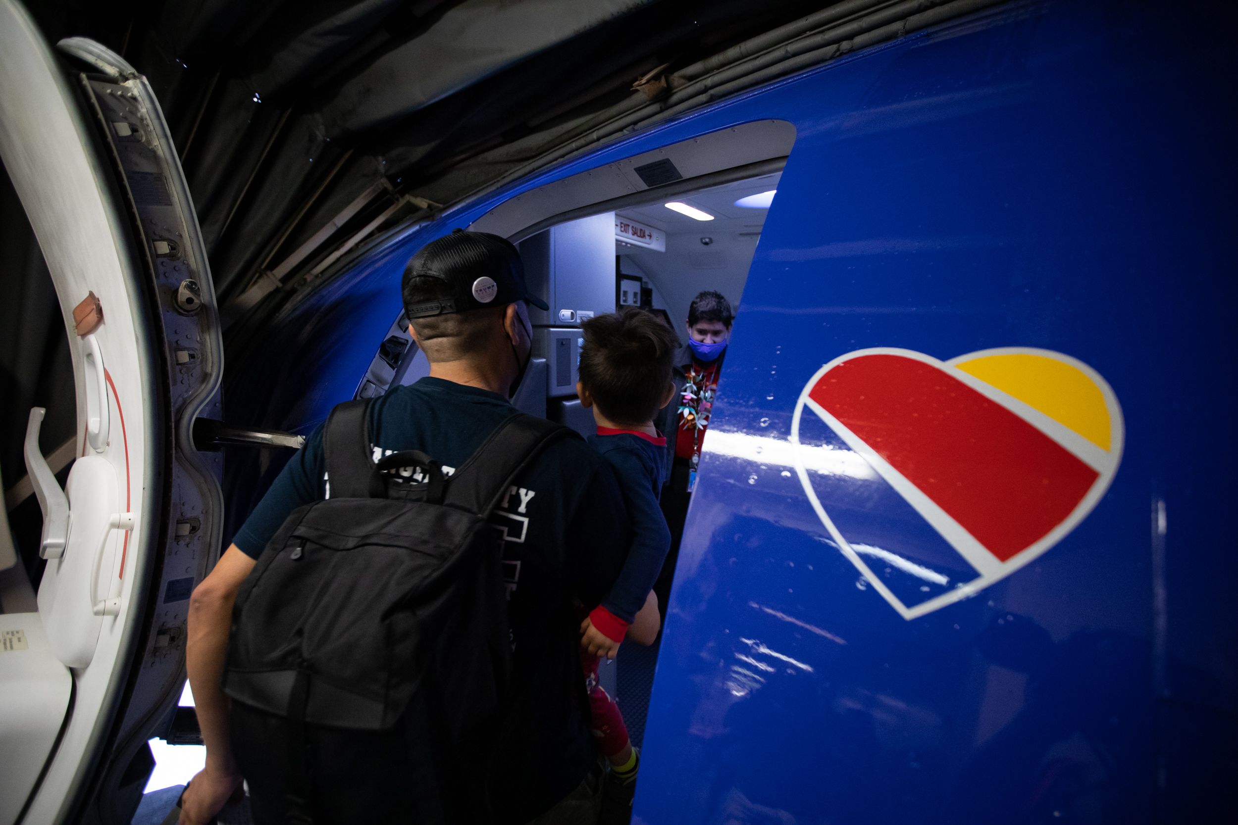 A Father and child board a Southwest Airlines Boeing 737