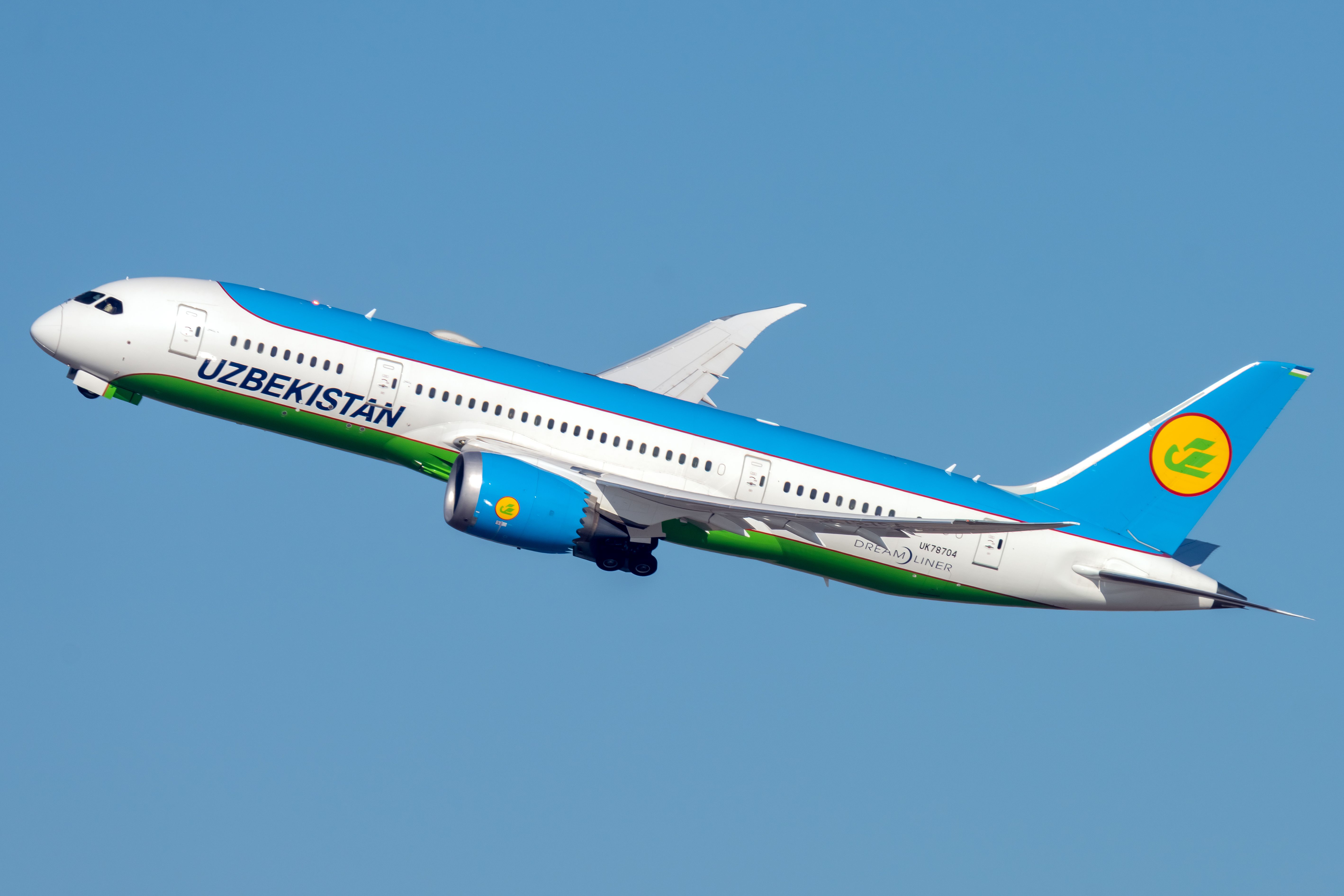 An Uzbekistan Airways Boeing 787-8 Dreamliner flying in the sky.