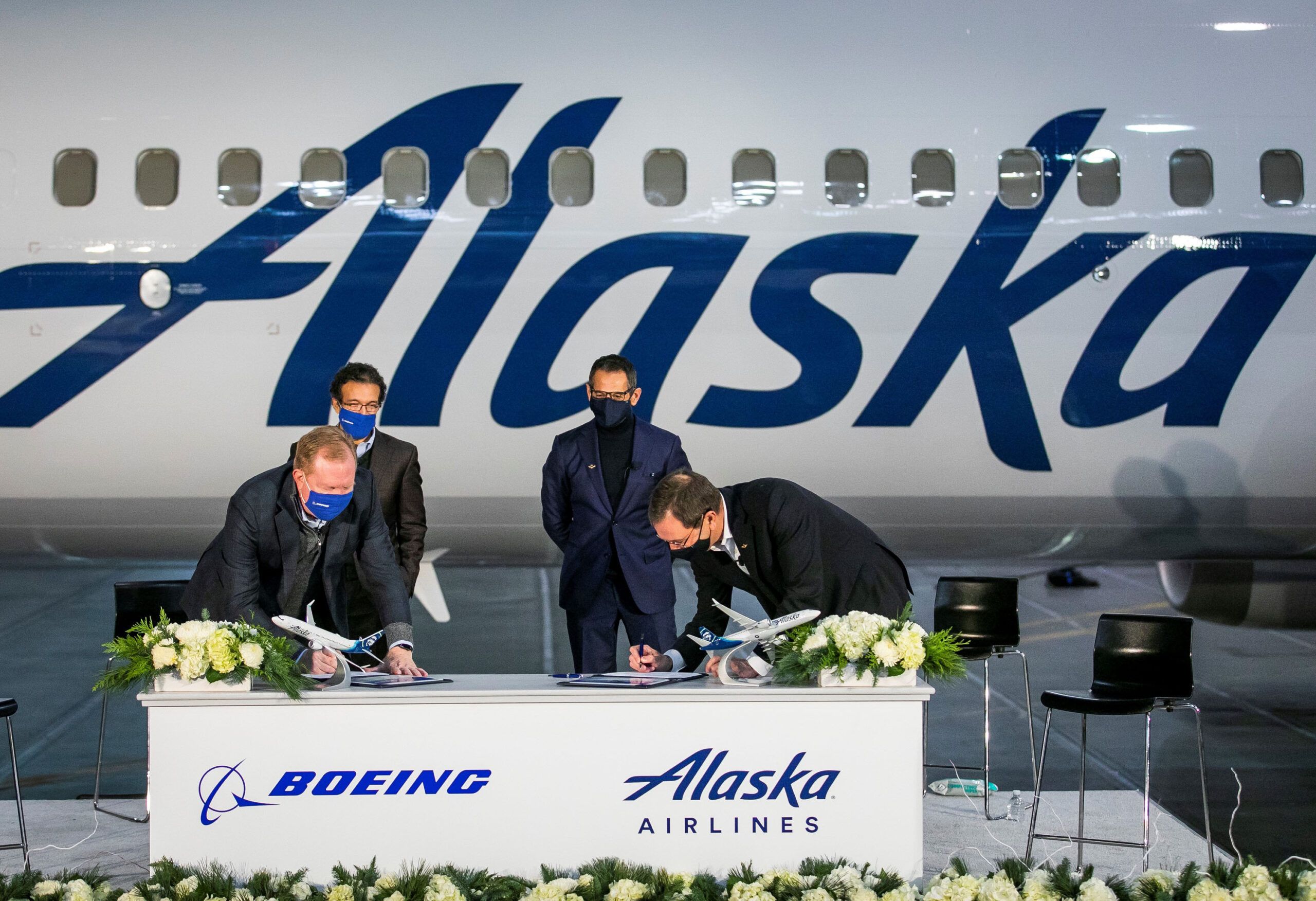 Alaska and Boeing signing acceptance of 737 MAX jets in front of a 737 MAX