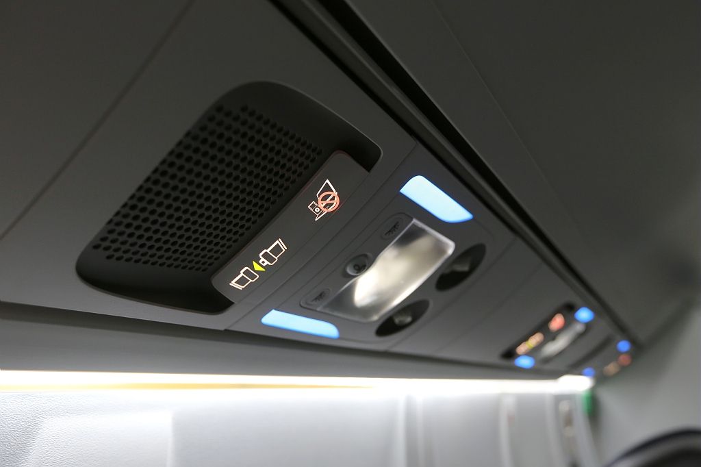 Overhead illuminated signs in an aircraft cabin.