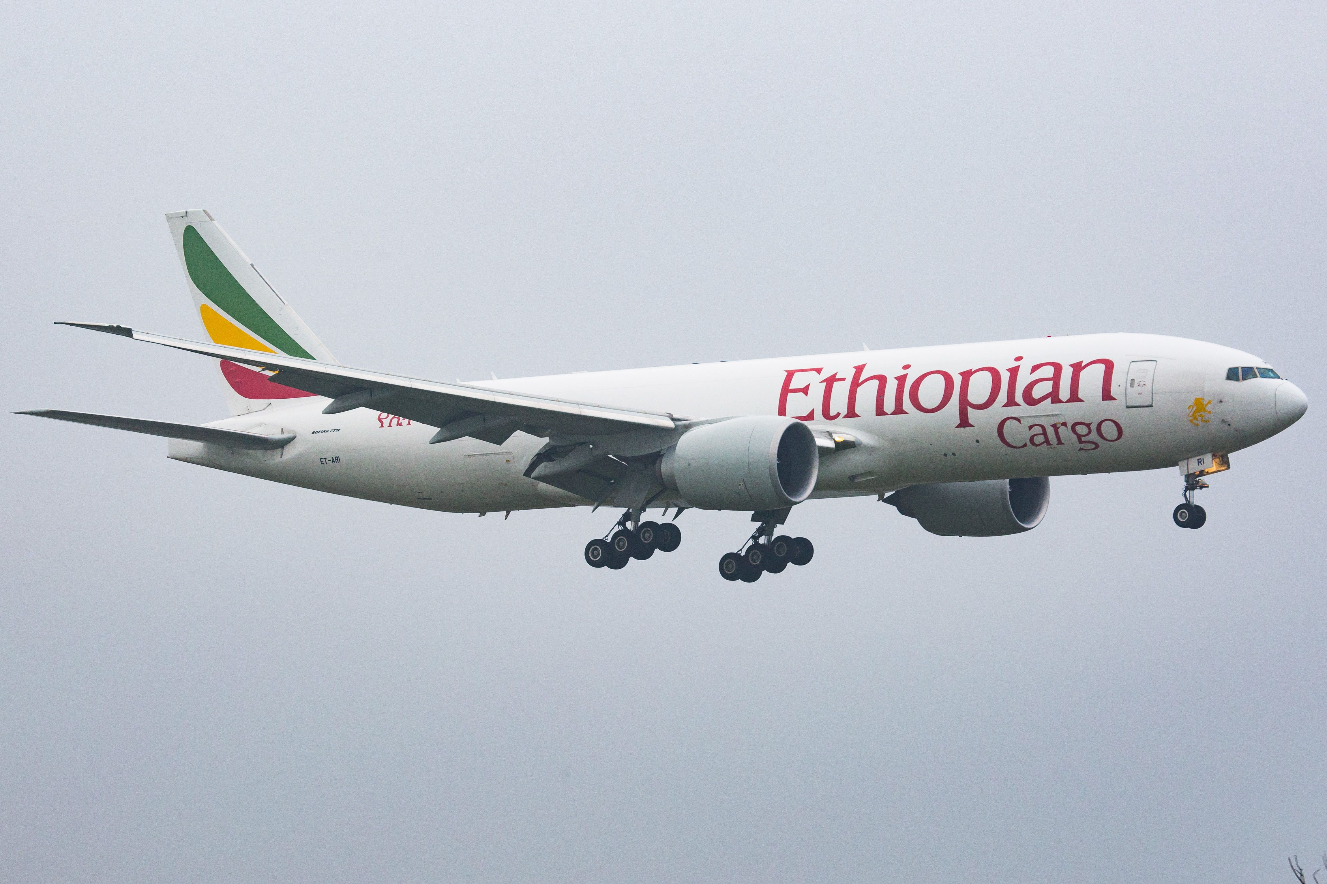Ethiopian Airlines 777 freighter landing against grey sky