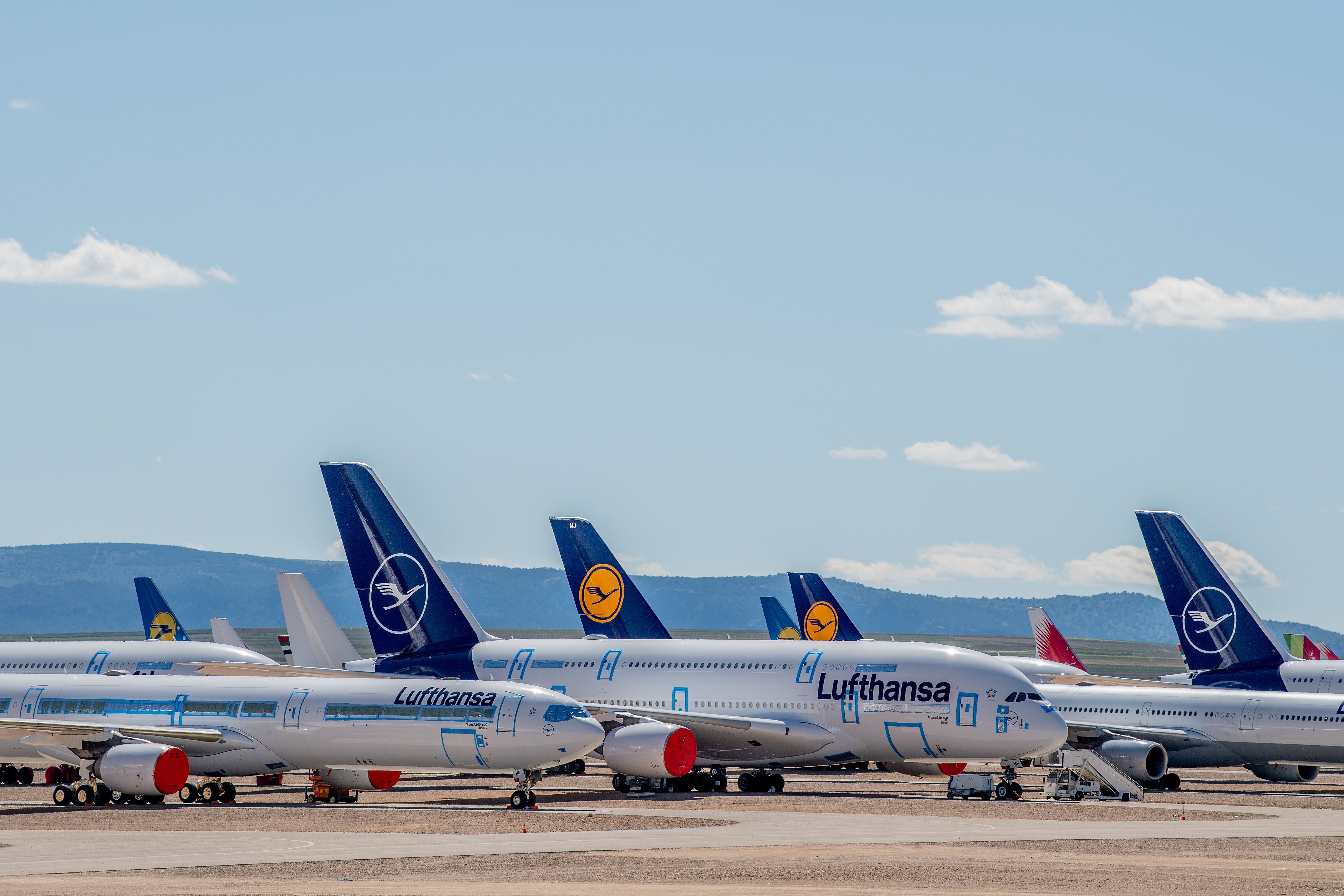 A Lufthansa Airbus A380 is shown wrapped up and protected from the elements, surrounded by other stored aircraft in Teruel, Spain.