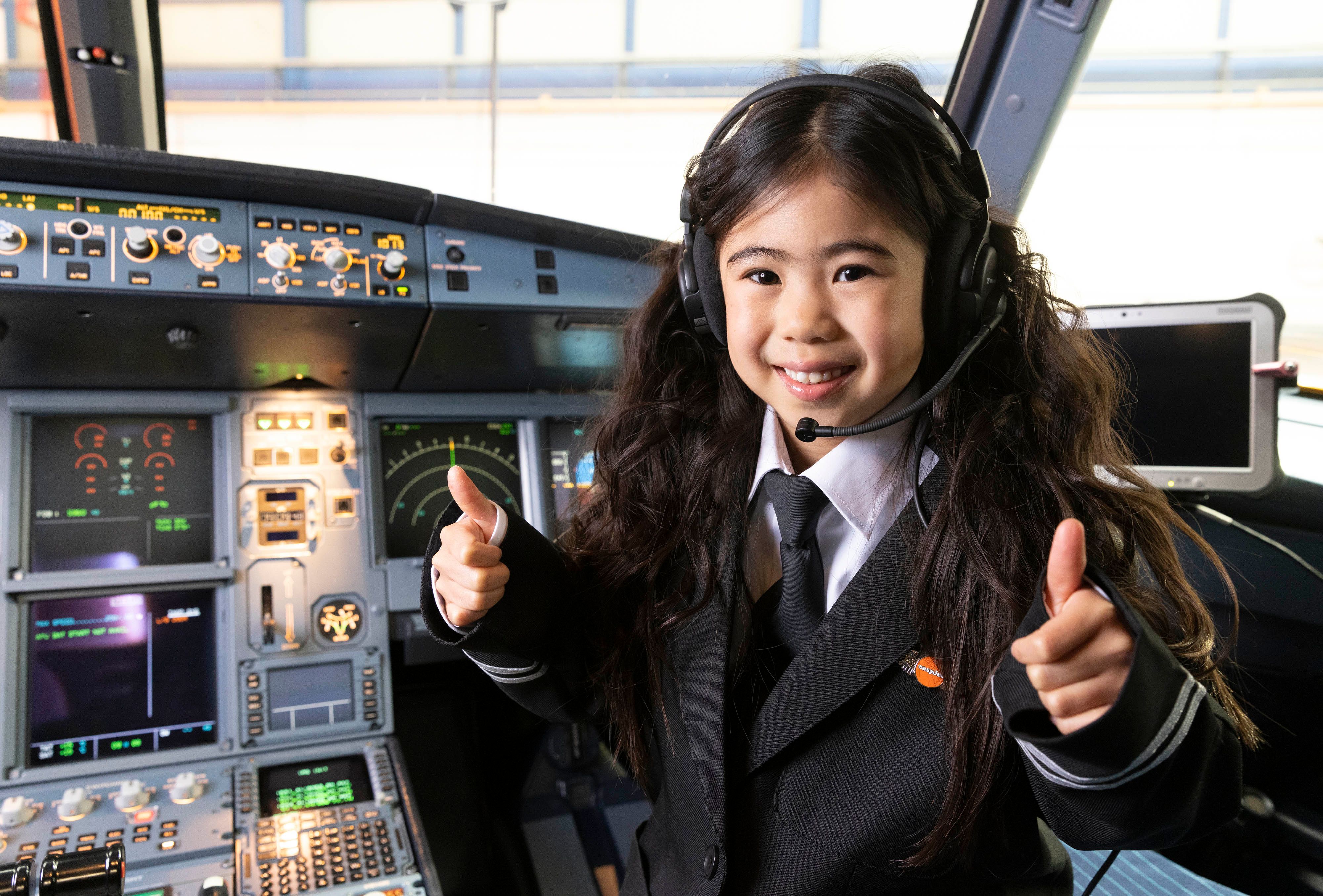 Girl in pilots uniform on flight deck