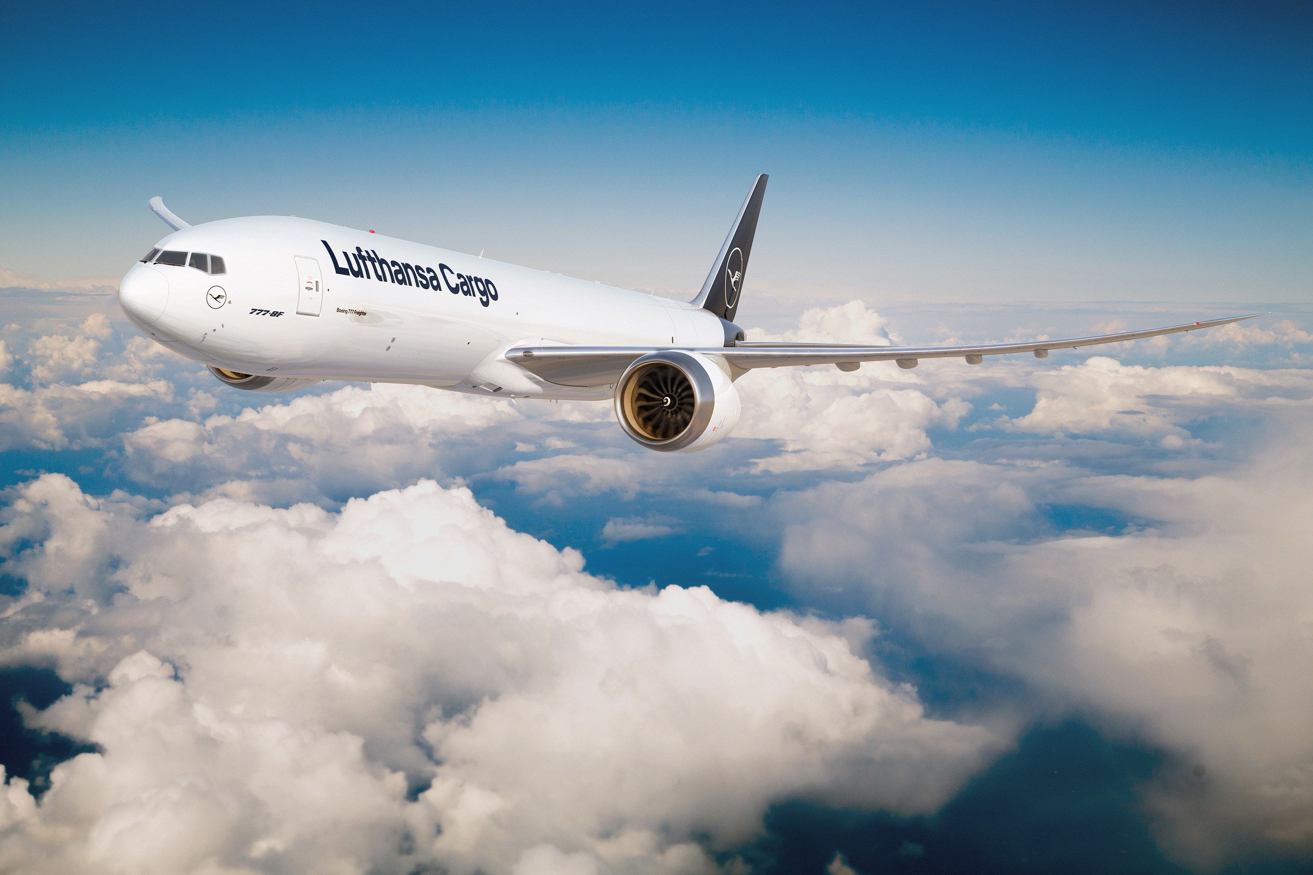 A render of a Lufthansa 777-8F flying above the clouds.