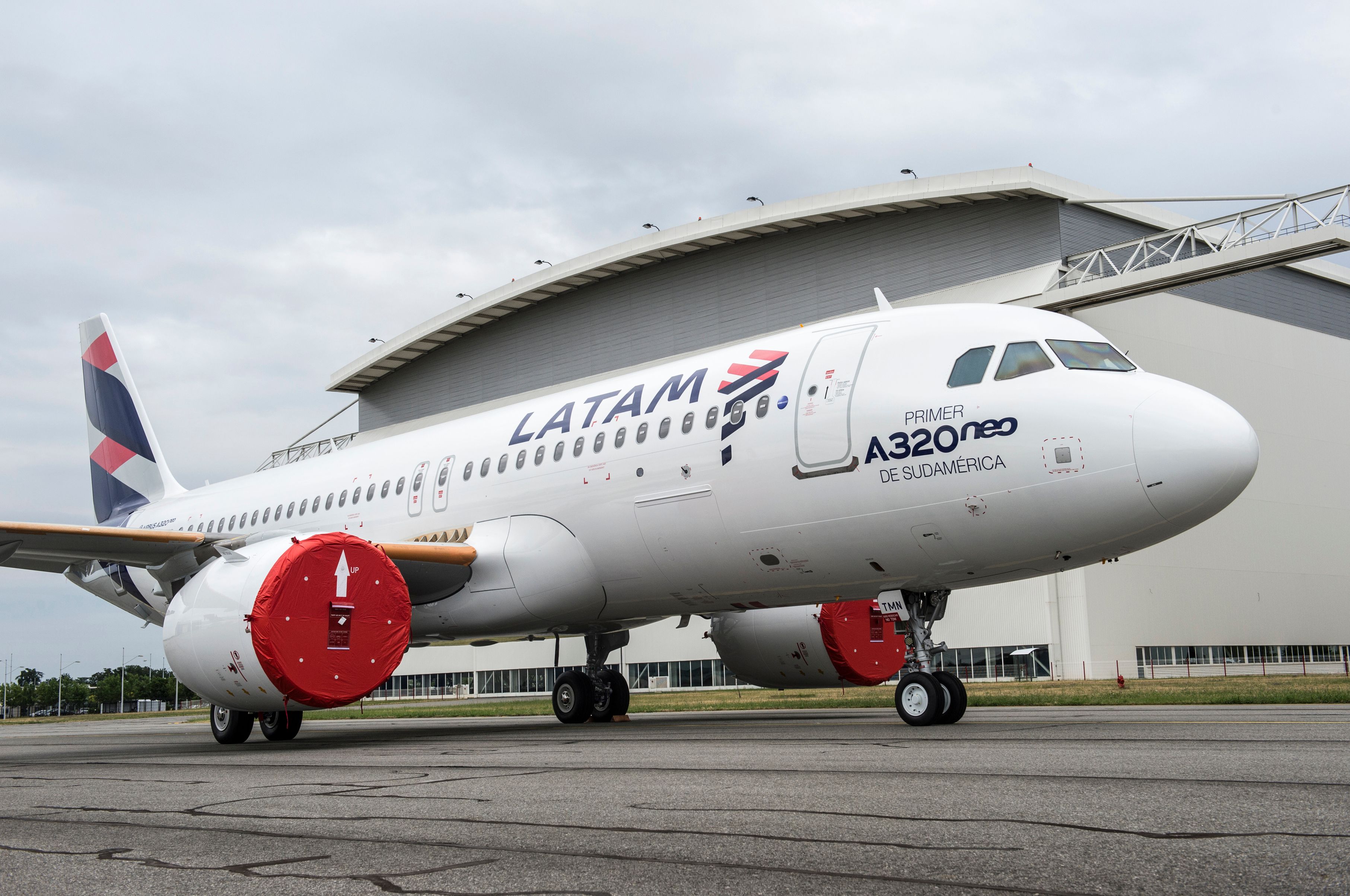 A LATAM A320neo, with a livery that says 'First A320neo in South America' parked. 