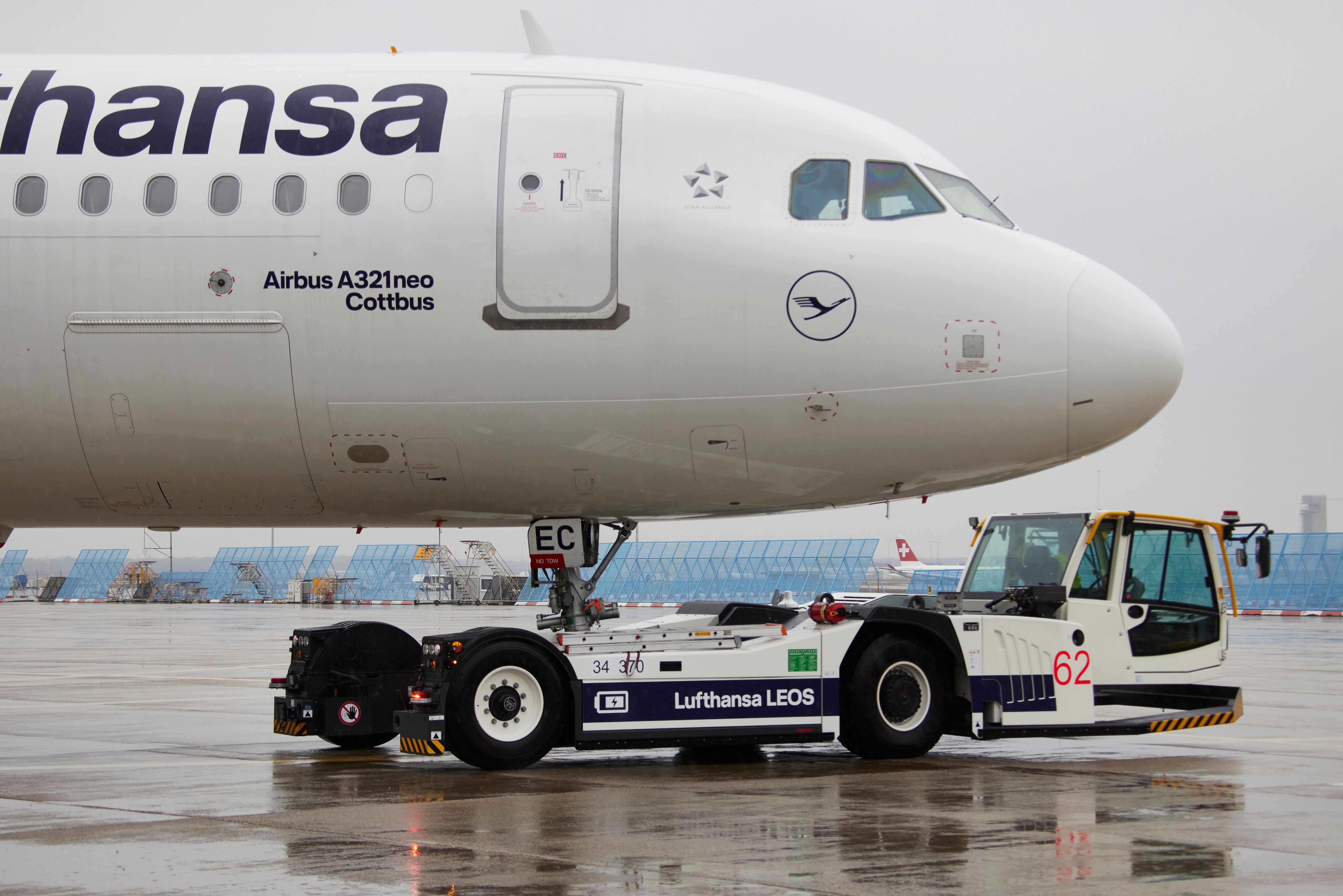 Lufthansa A320neo aicraft being tugged by ground support vehicle