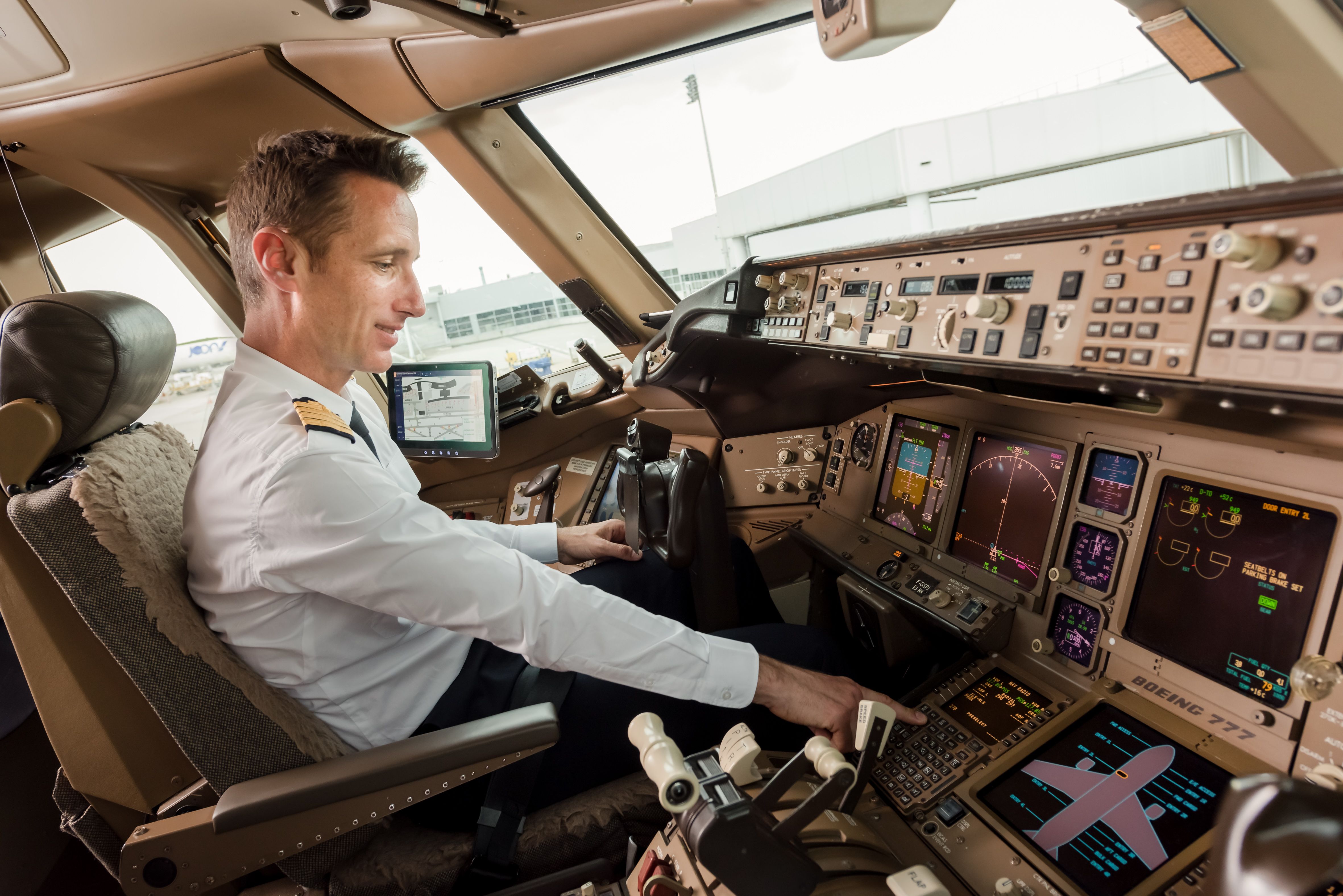 An Air France pilot interacting with the ACARS system in the cockpit.