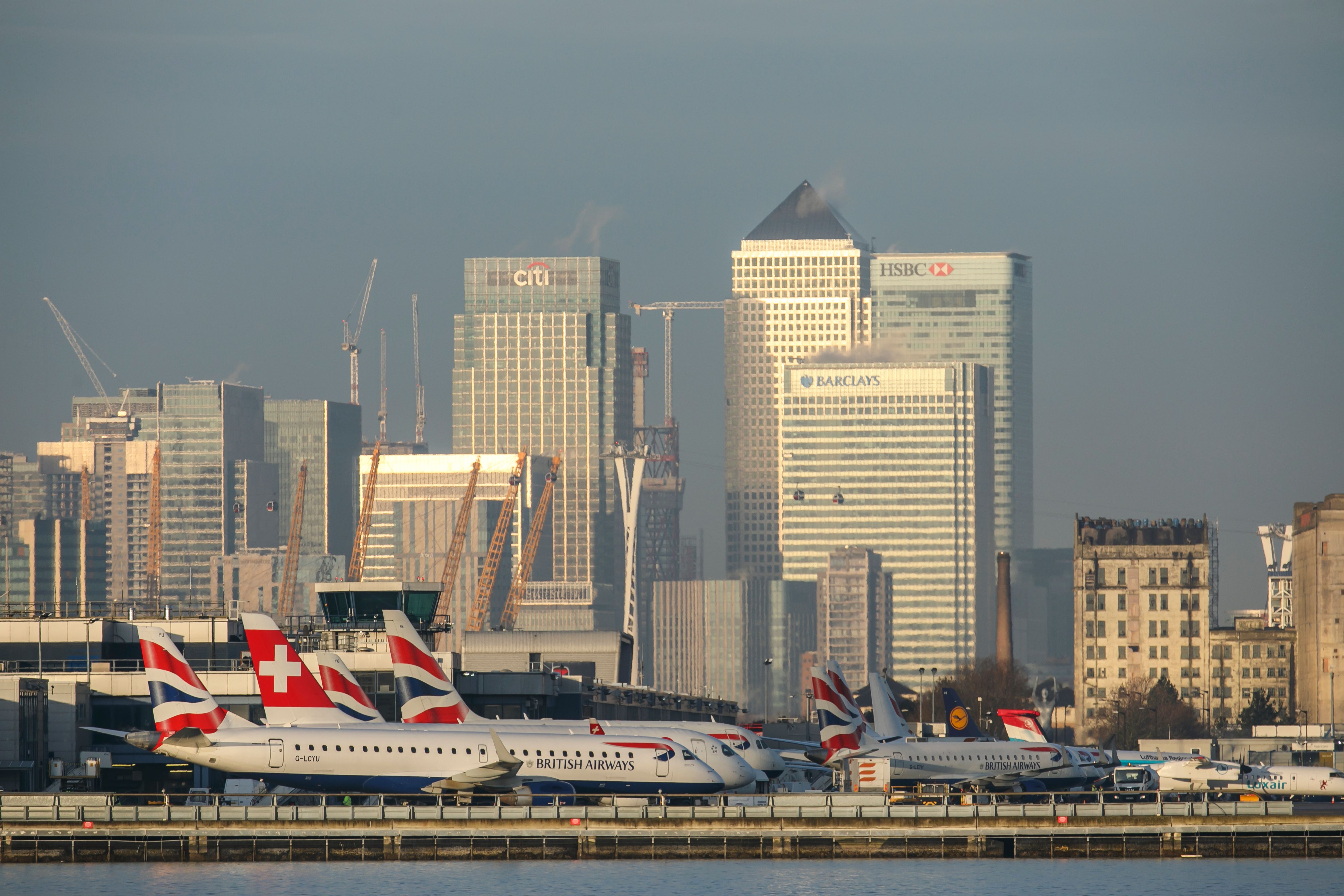 Aircraft parked at LCY in front of London skyscrapers 
