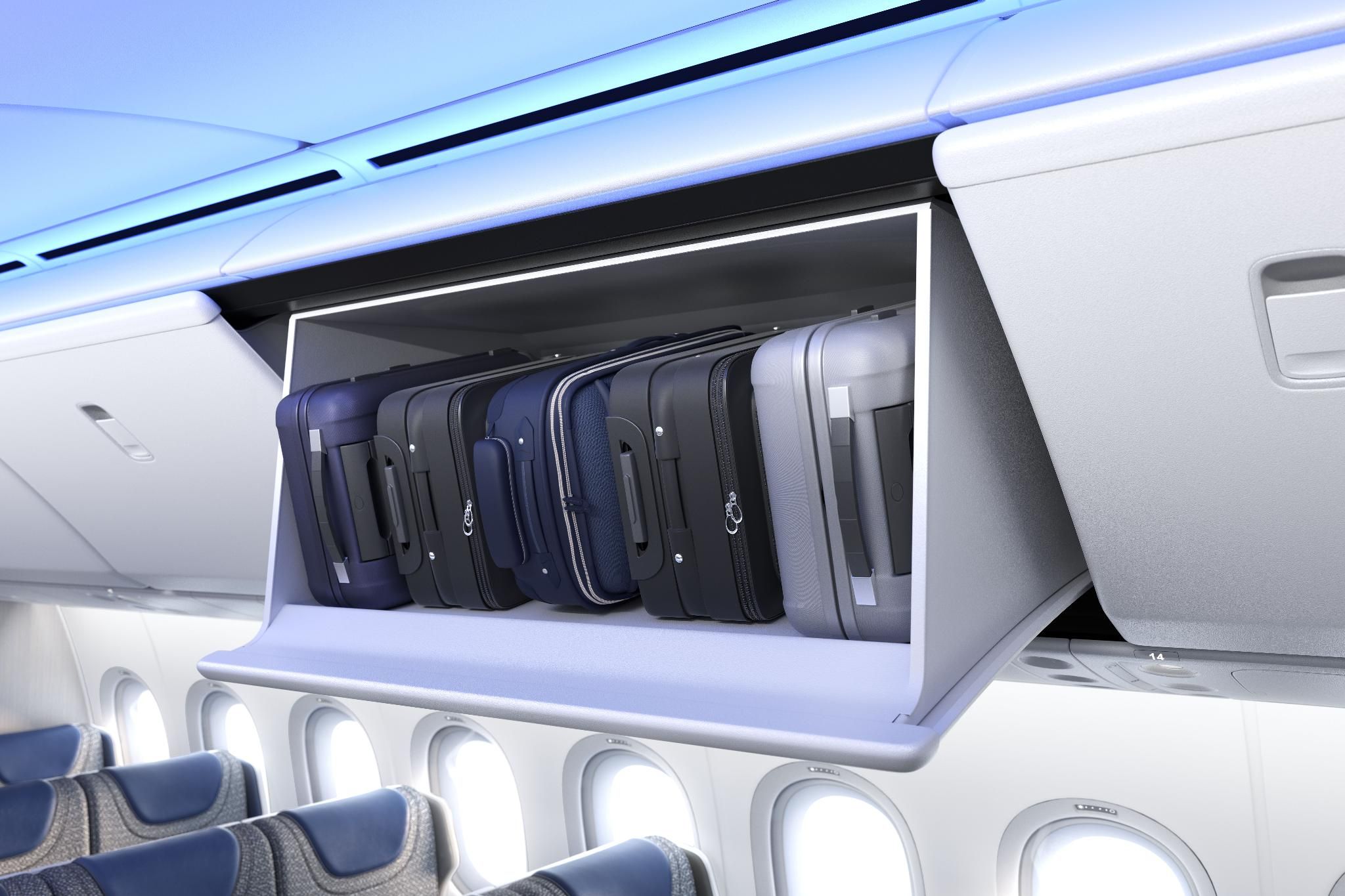 five carry on suitcases in an overhead bin onboard the Boeing 777X.