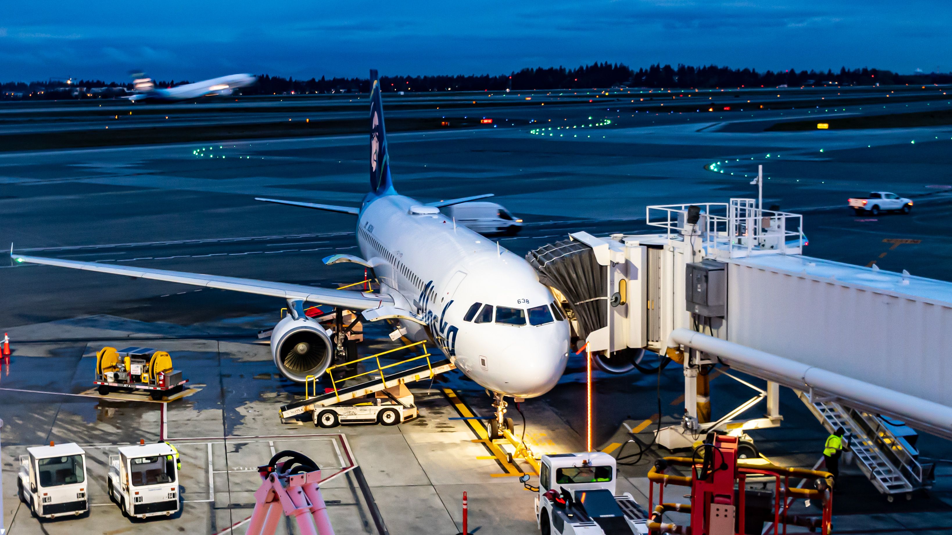 A Busy Sea-Tac Tarmac In the Morning Blue Hour - Complete With an Alaska Airlines Jet Taking Off in the Background and an A320 at a Sea-Tac Gate