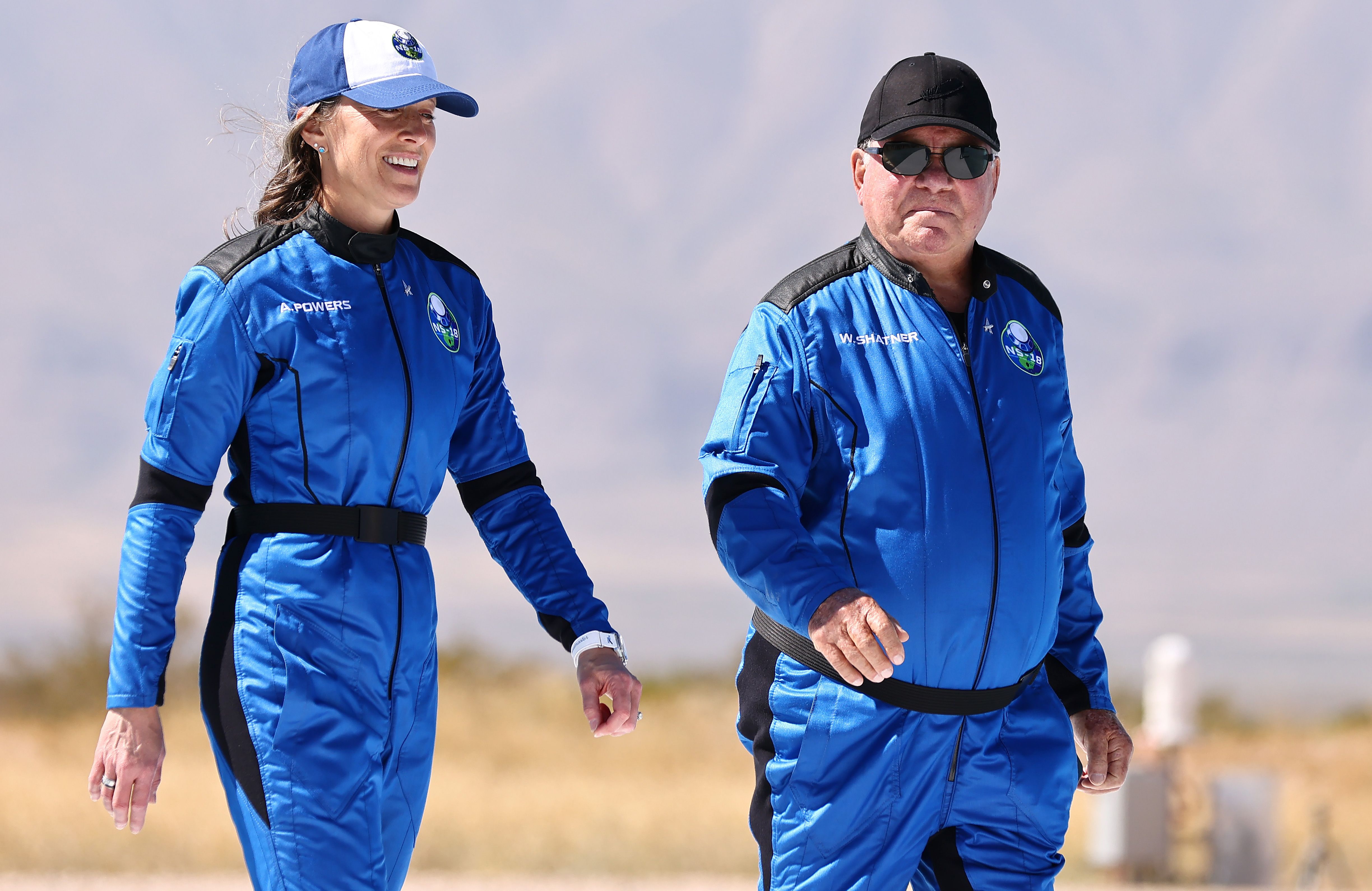 Shatner and Blue Origins Vice President of Mission & Flight Operations, Audrey Powers walking together