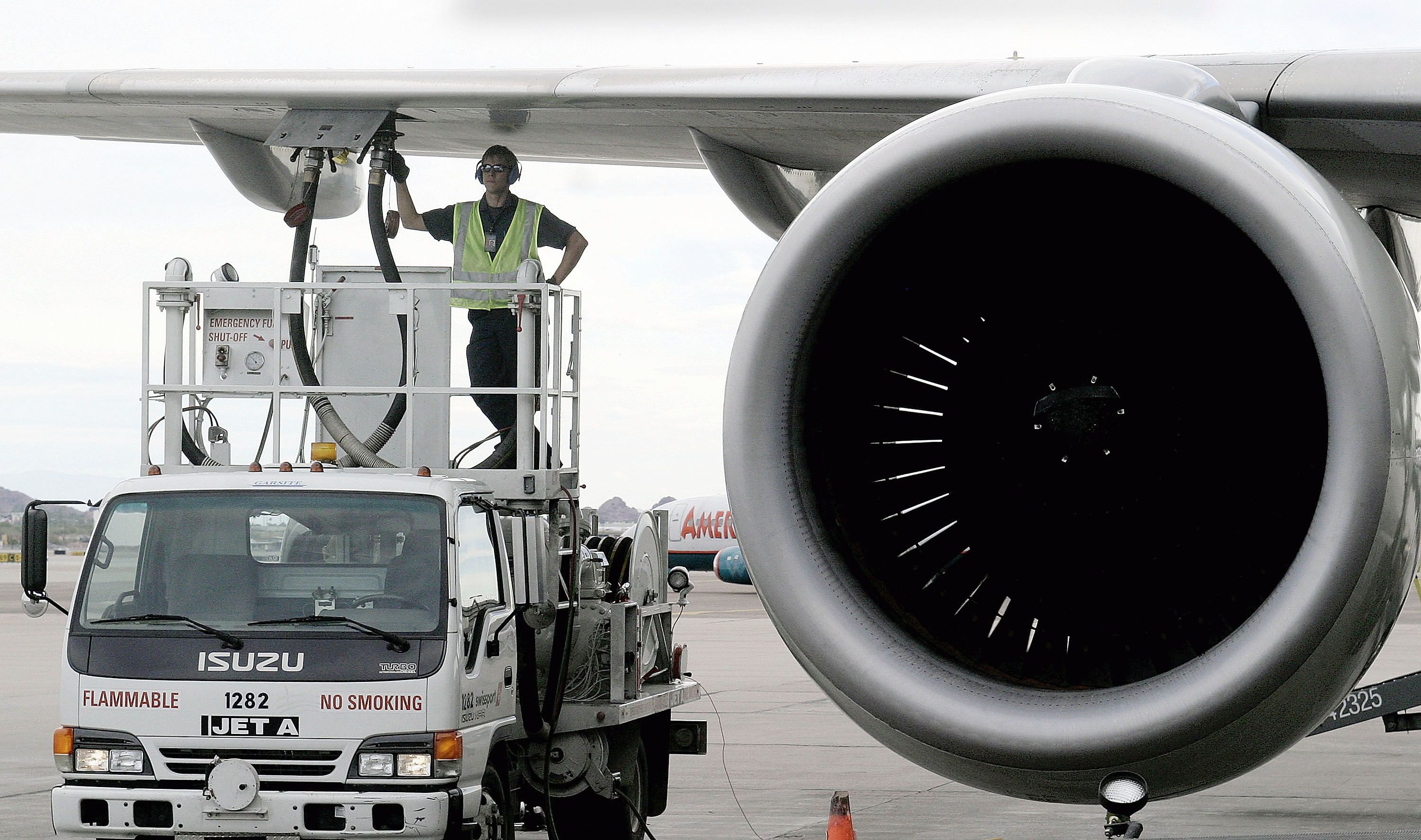Aircraft being refueled with close up of engine