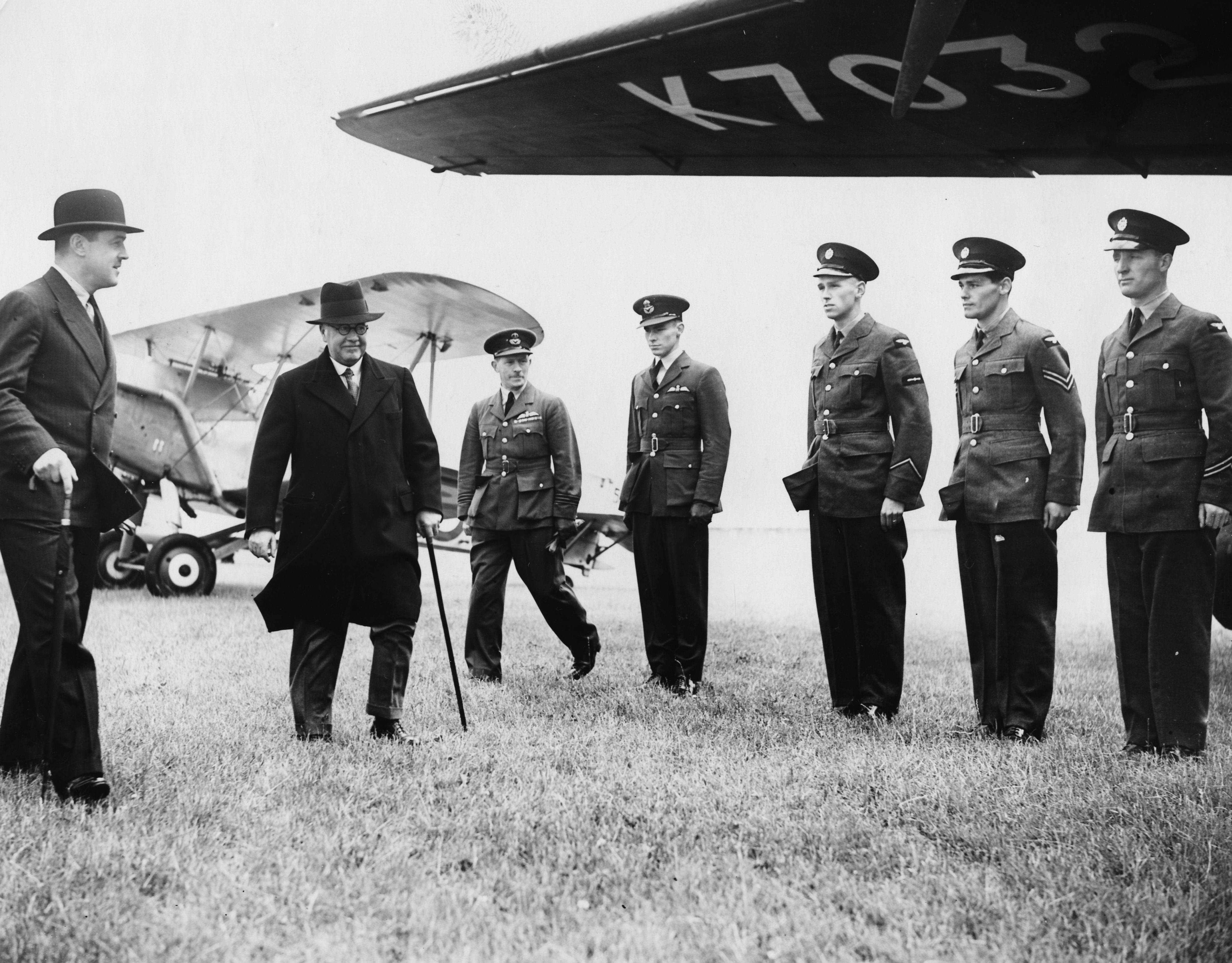 GettyImages-551452639 - British Air Minister Sir Kingsley Wood inspecting the aircraft, flanked by RAF airmen, as he opens the new Manchester Airport, England, June 26th 1938. (Photo by Fox Photos/Hulton Archive/Getty Images)