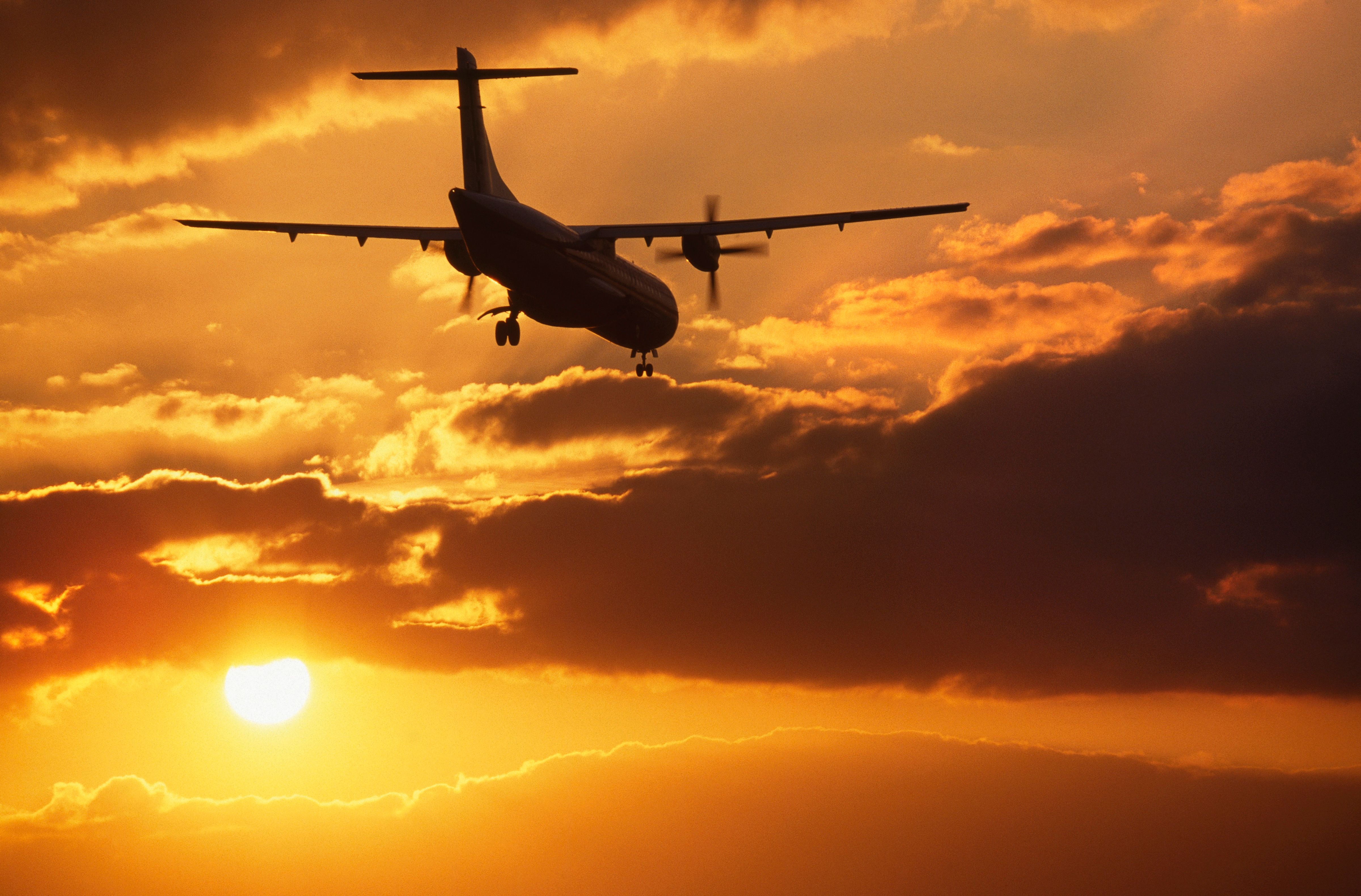 ATR 72 turboprop on approach at sunset