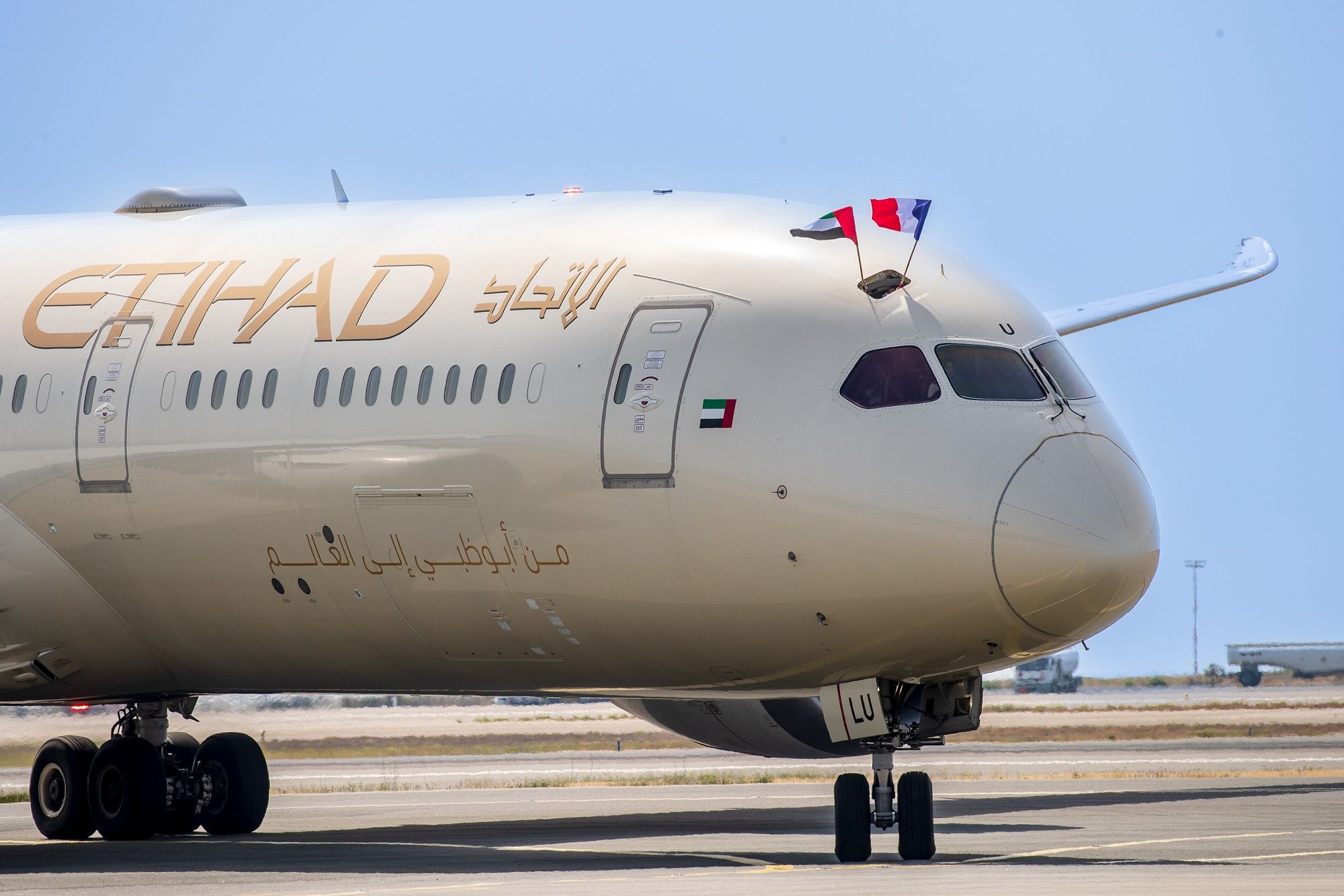 Etihad Airways pilots wave French and UAE flags after the carrier's first Abu Dhabi-Nice flight touches down on 15 June 2022, one of five seasonal routes that the airline is operating during the 2022 summer season