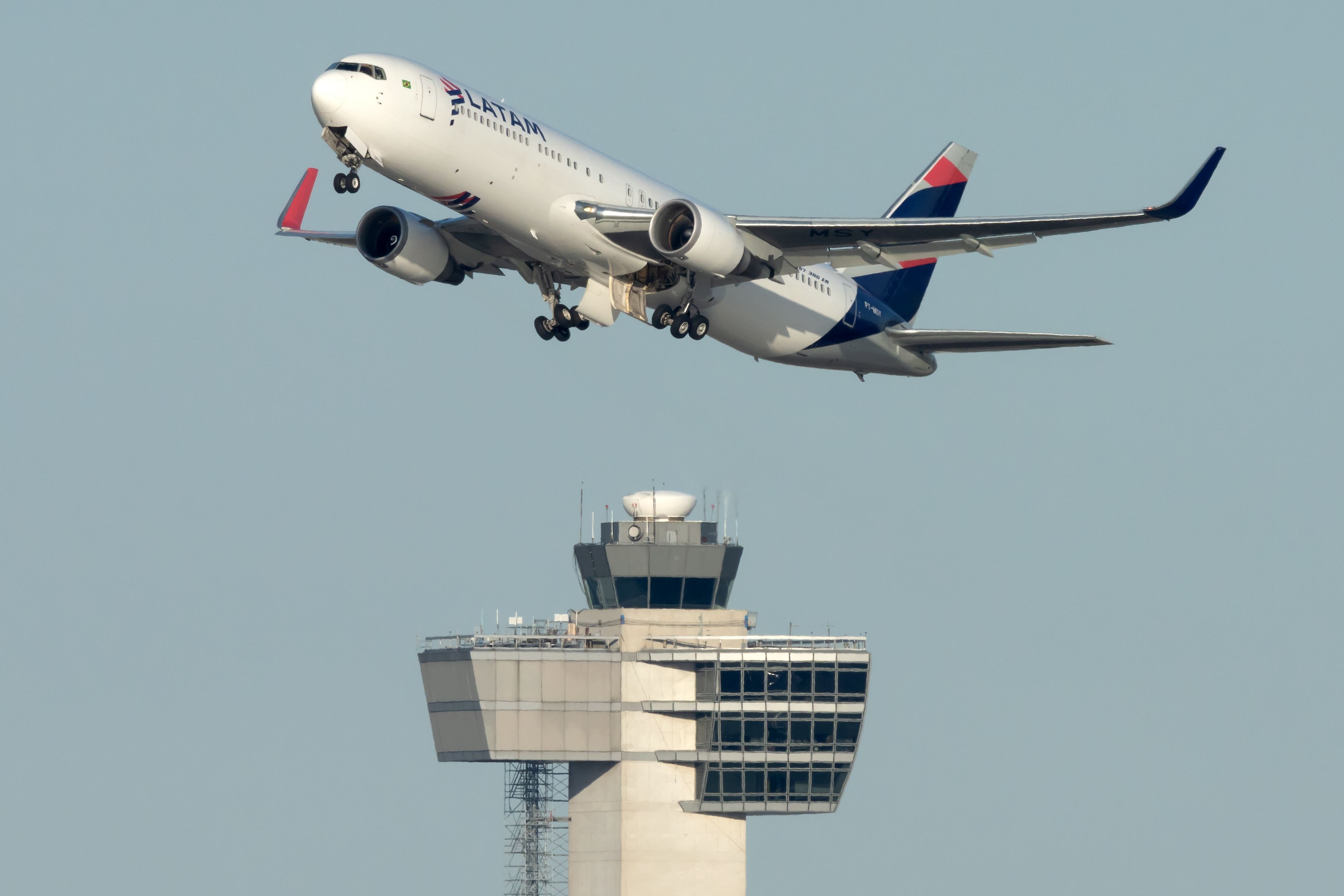 A LATAM Boeing 767-300 departing from New York. The ATC tower can be seen in the back. 