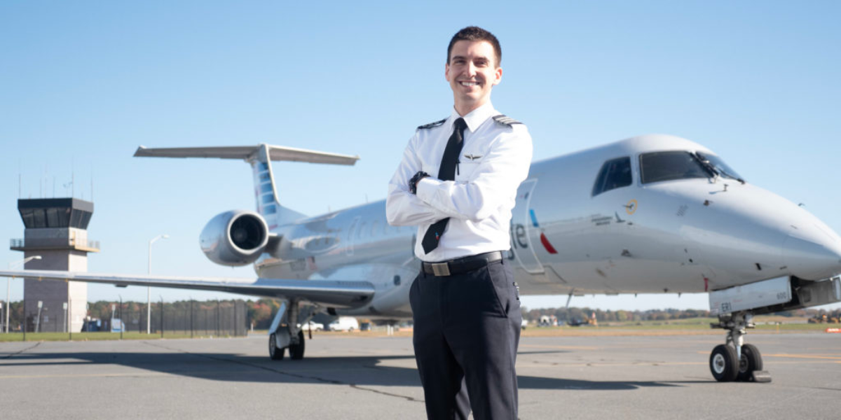 Piedmont Airlines First Officer Standing In Front of Embraer ERJ 145