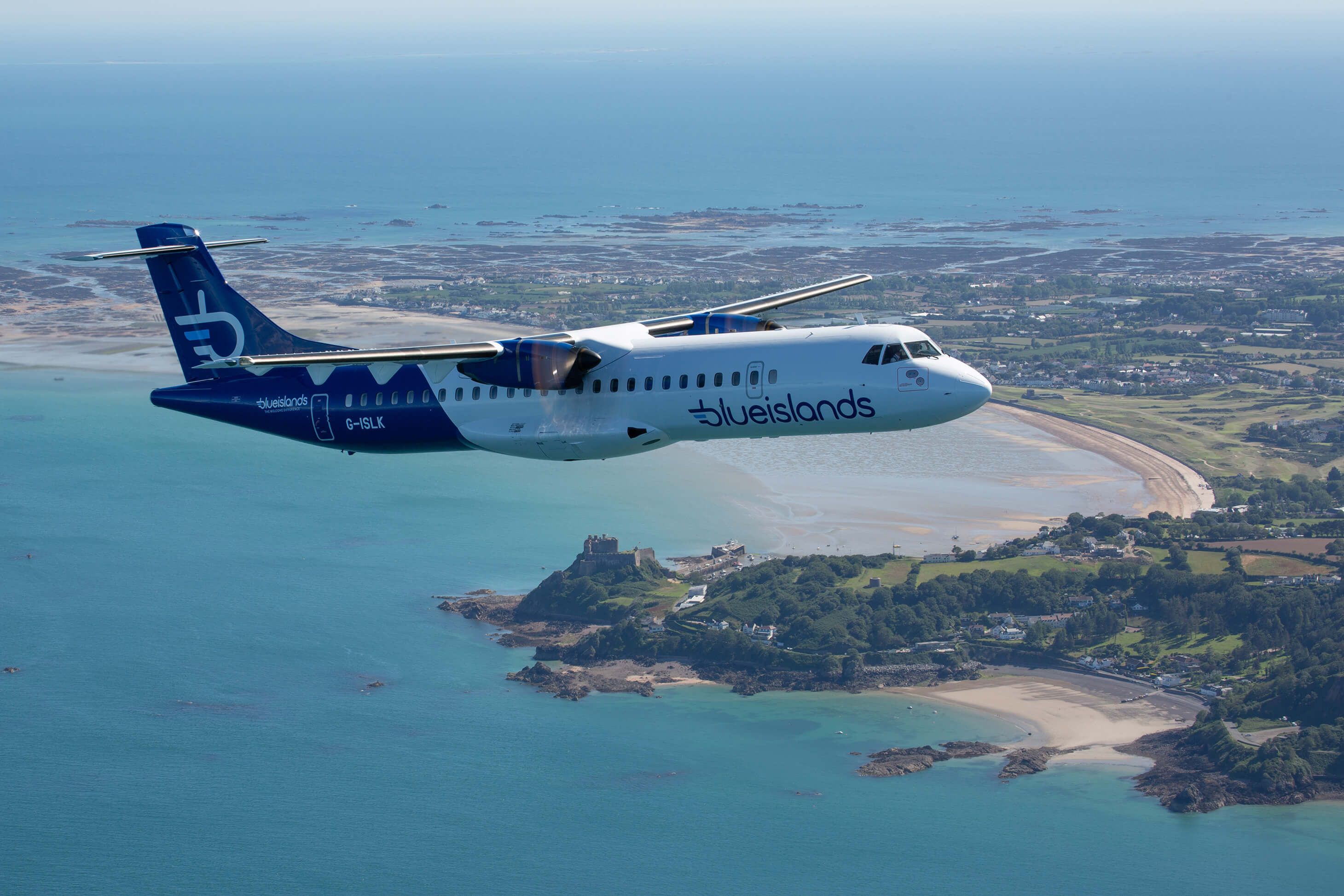 A Blue Islands ATR 72 flying over an island.