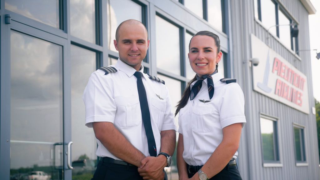 img_pilots_contract_extension - A Male & Female Piedmont pilot in uniform standing together