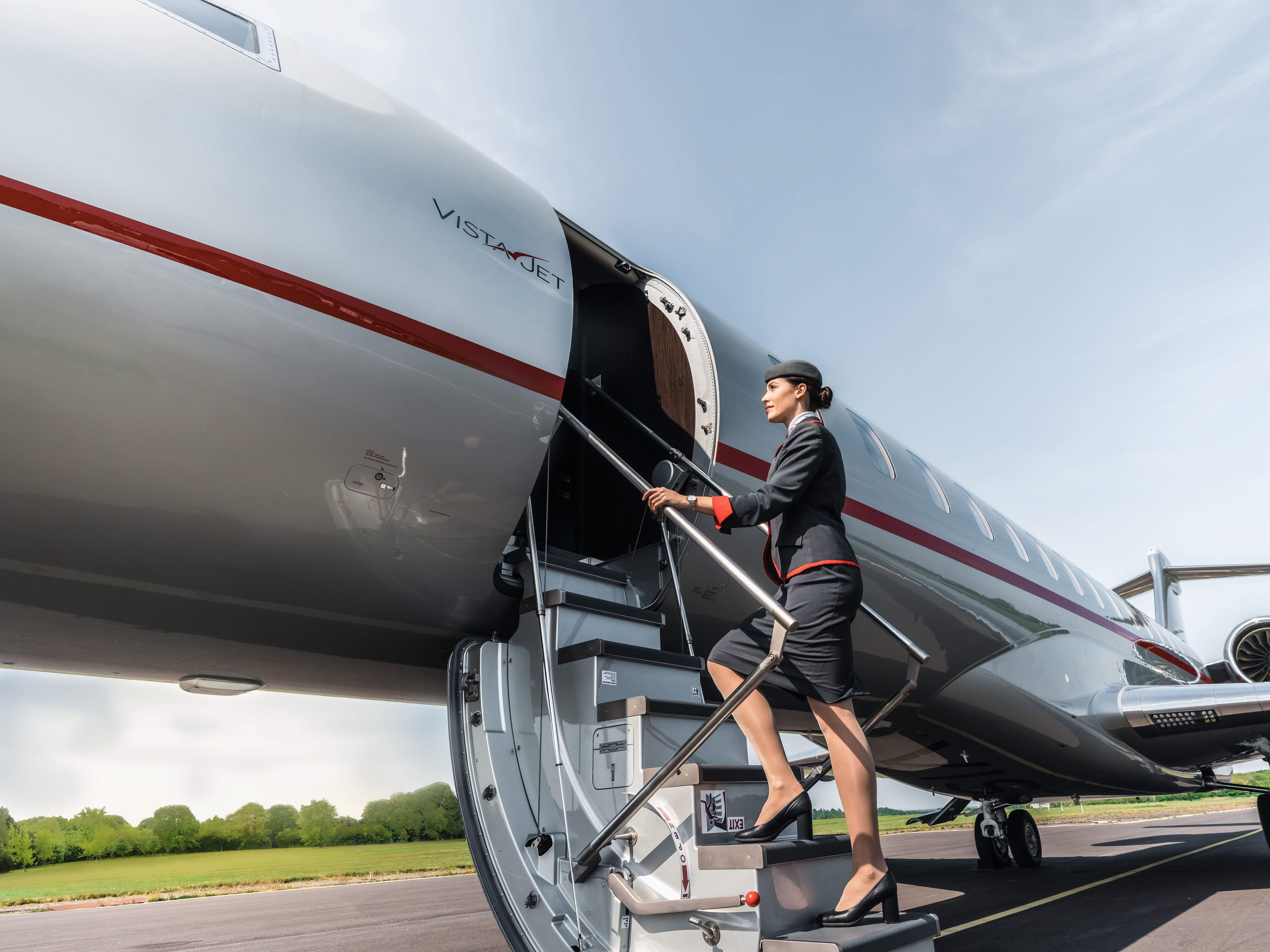 A vistajet cabin hostess boarding a private jet.