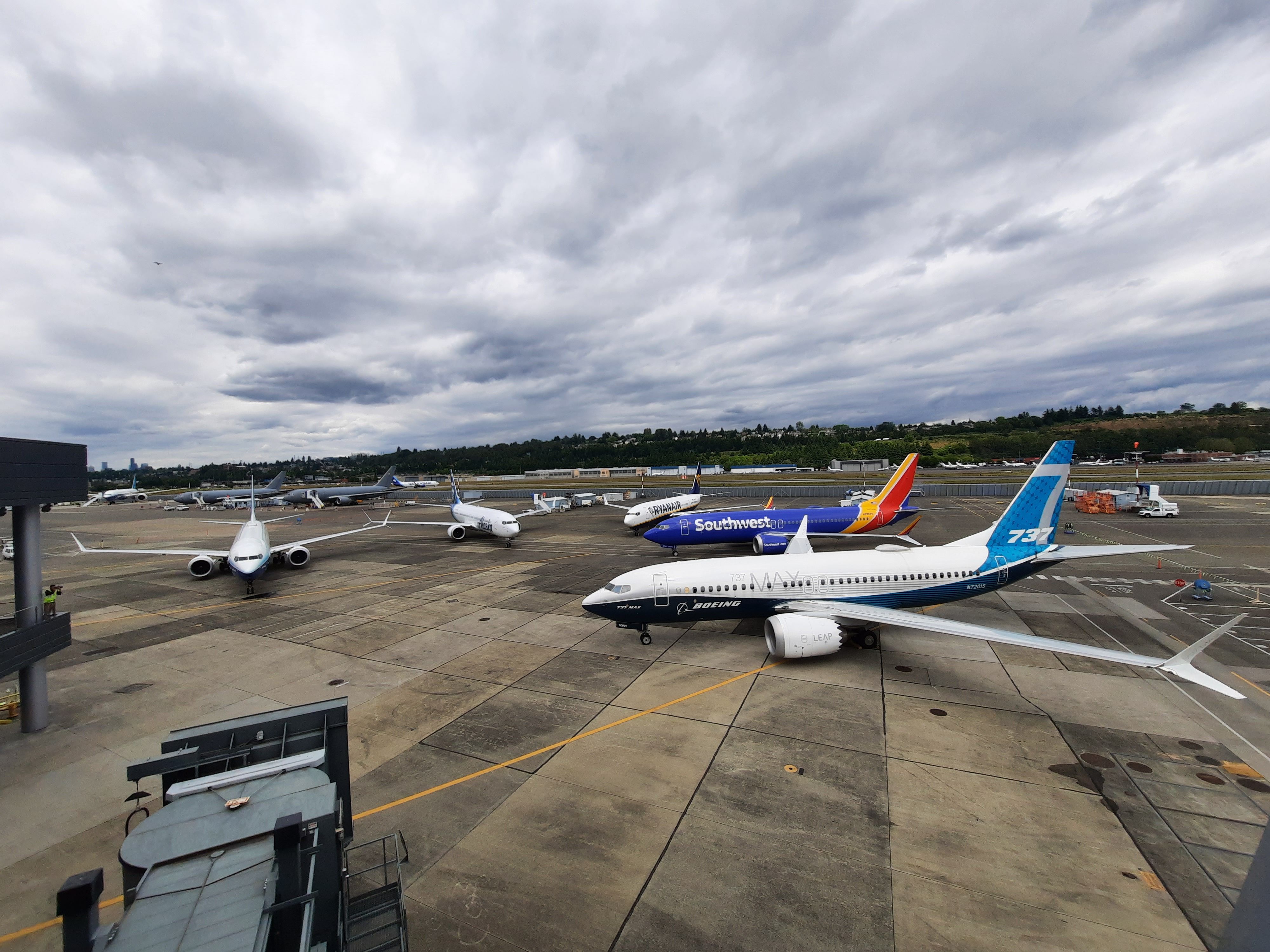 Several Boeing 737 MAX aircraft parked at an airport.