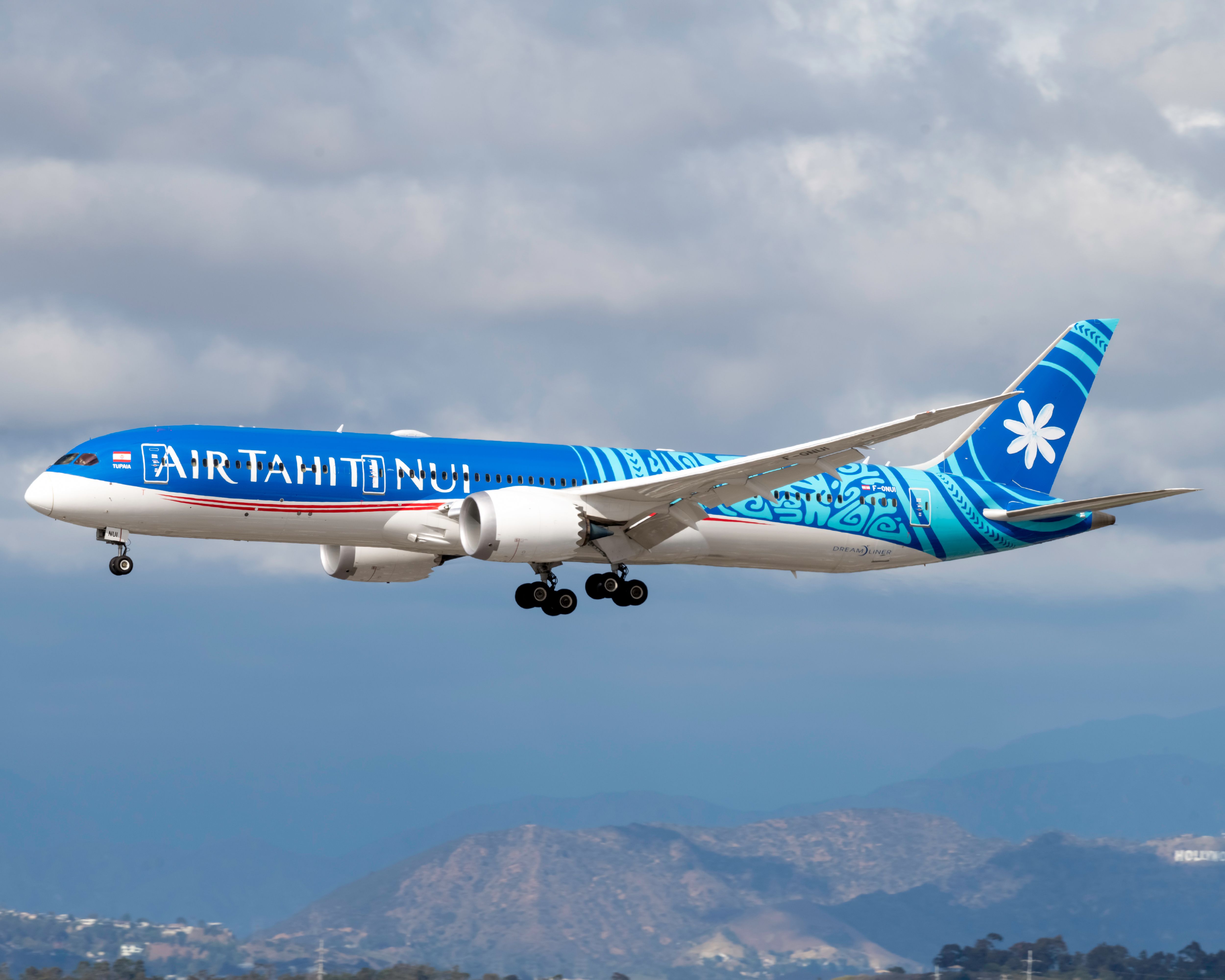 An Air Tahiti Nui Boeing 787-9 Dreamliner in flight close to the ground.
