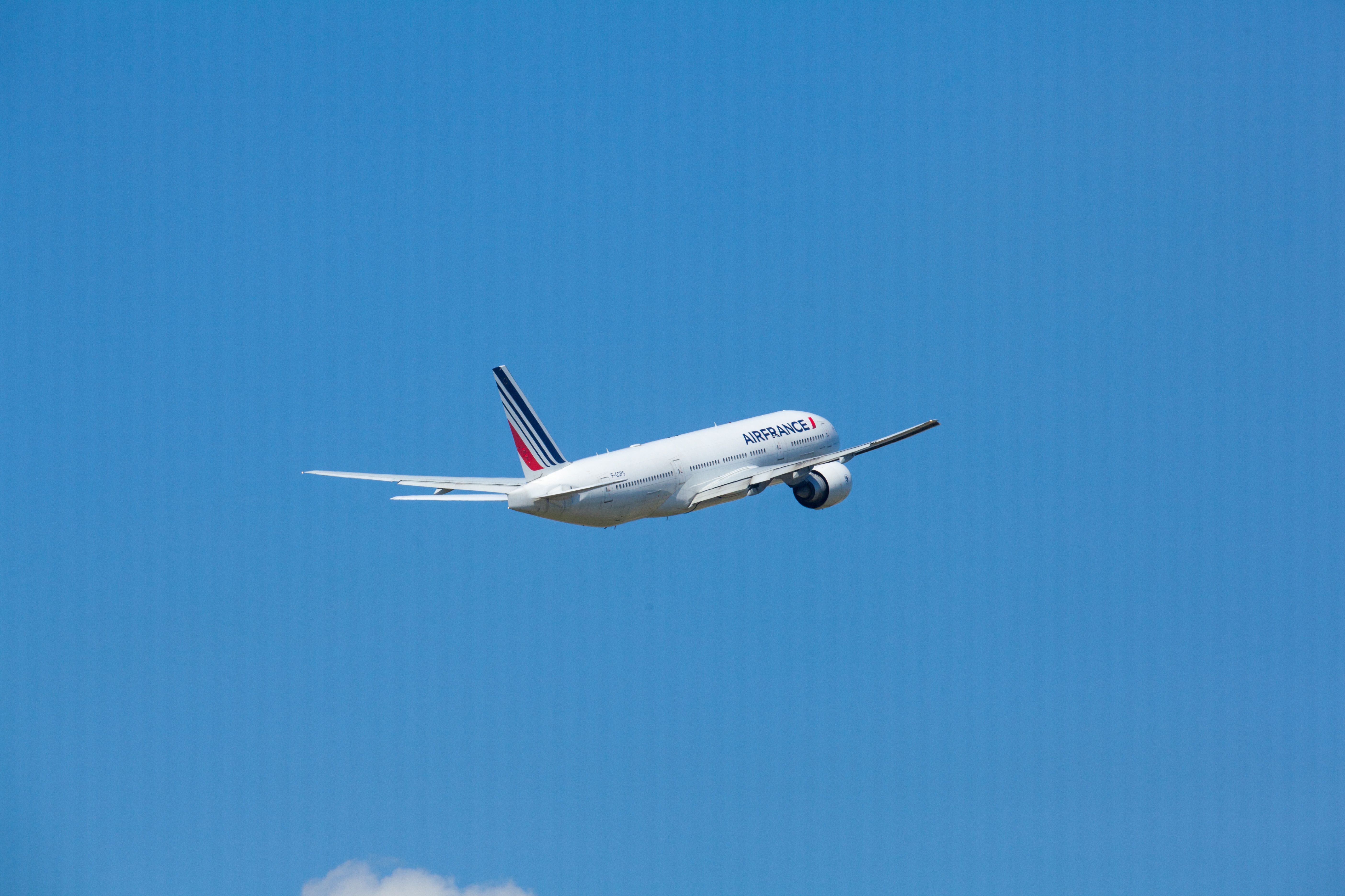 An Air France Boeing 777 flying in the sky. 