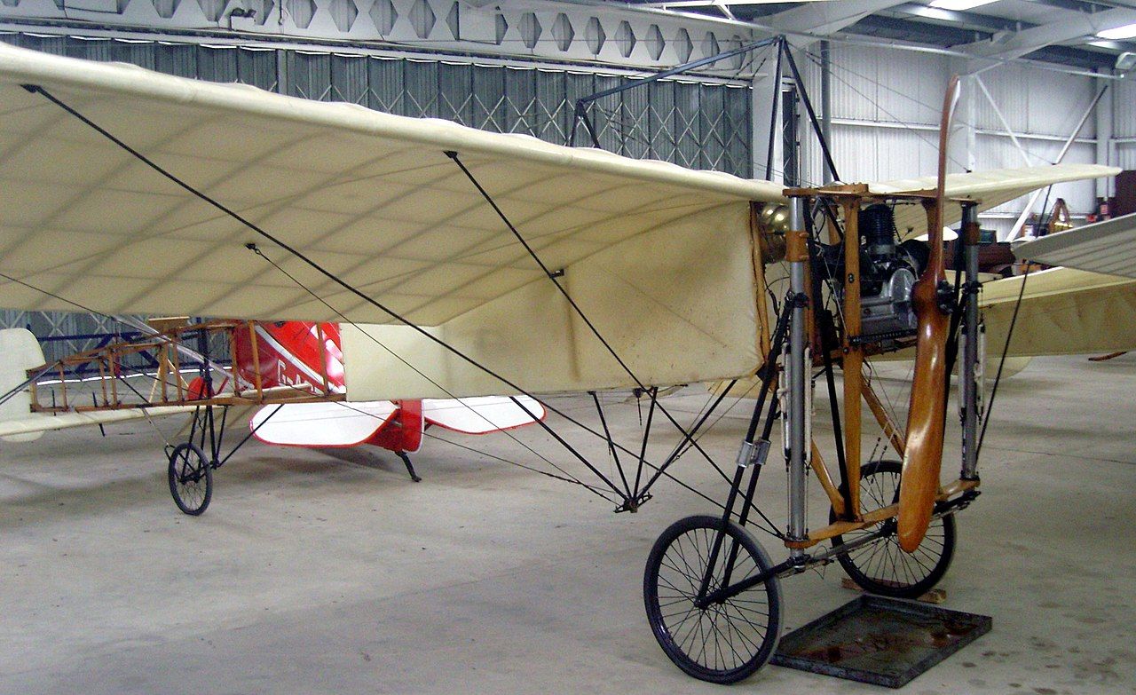 A Blériot XI parked in a hangar.