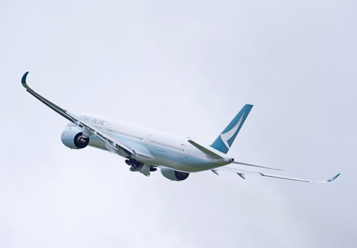Cathay Pacific Airbus A350-1000 taking off against blue sky