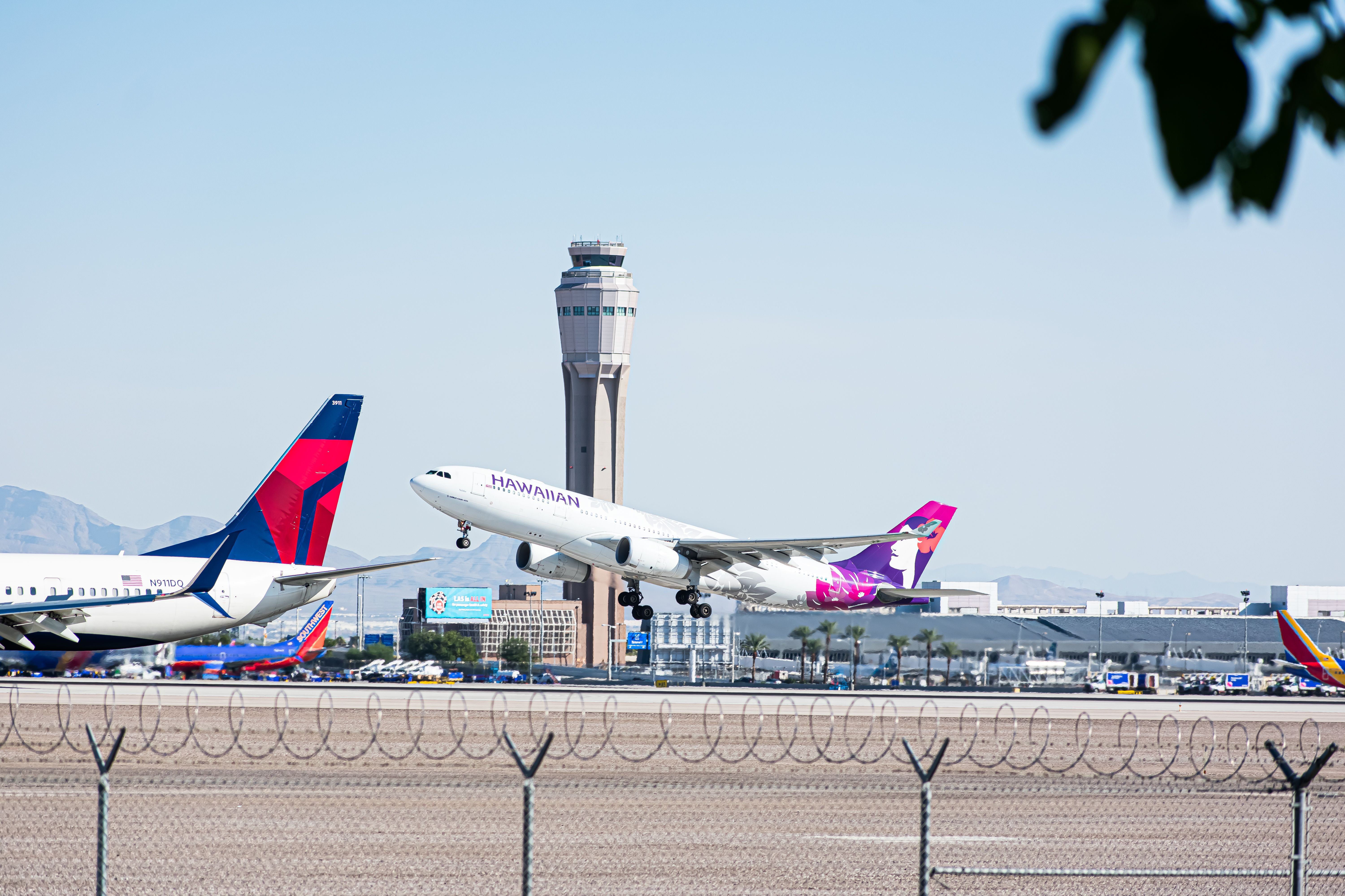 Hawaiian Airlines Airbus A330 / Tail of Delta Boeing 737 @ LAS