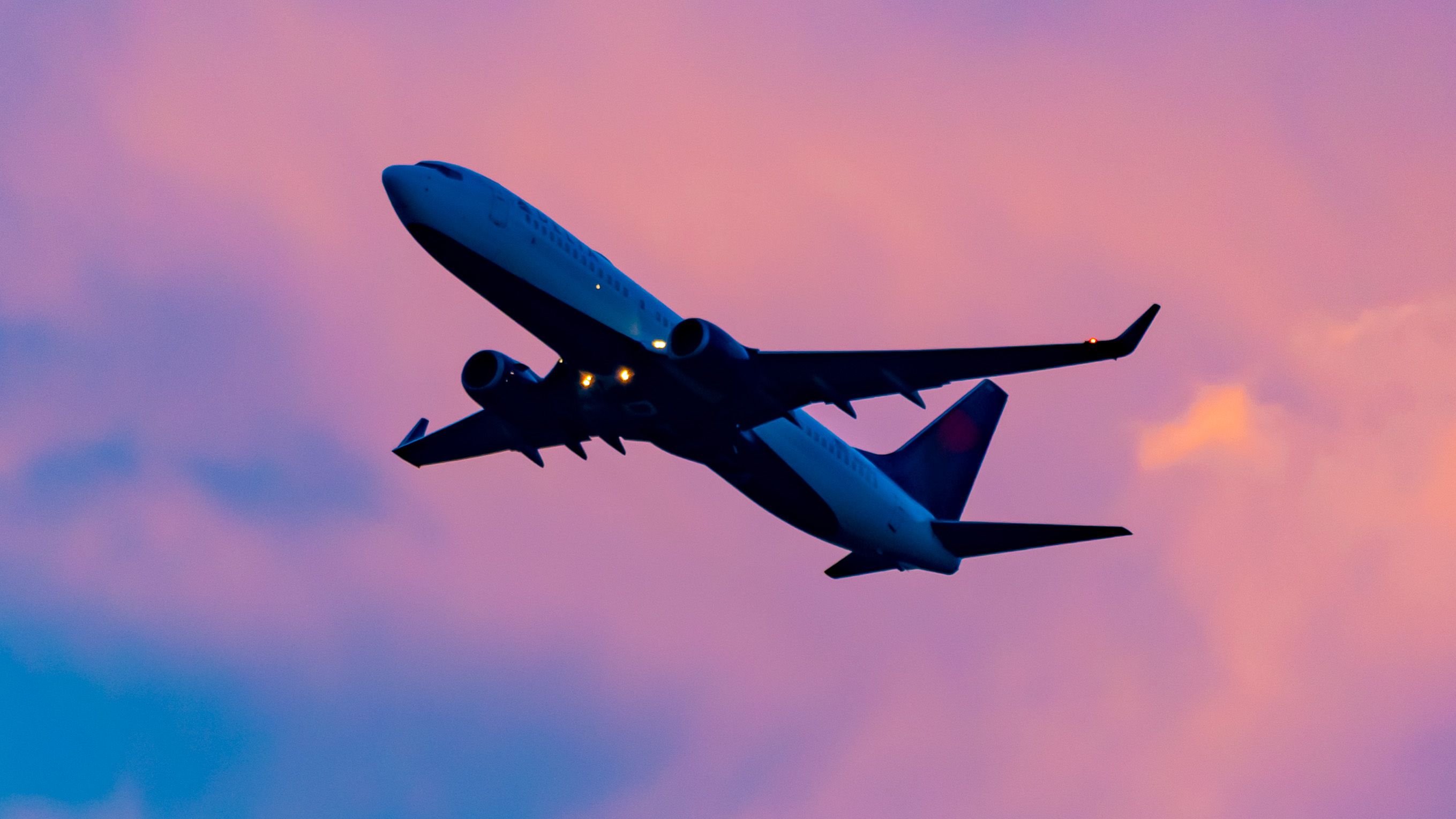 A Delta Air Lines Boeing 737-832(WL) Rising Into A Purple Sunset