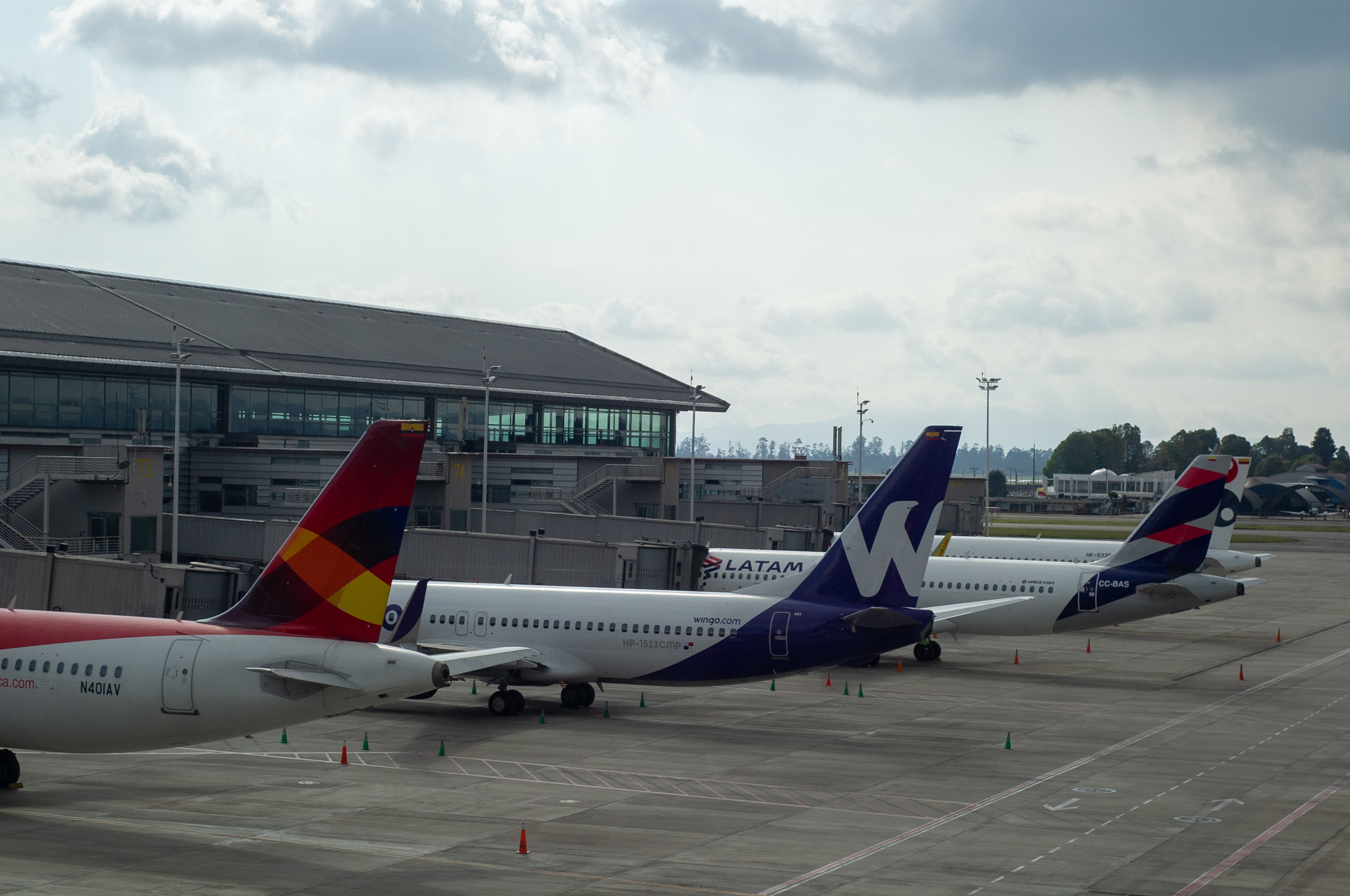 Four aircraft from four different airlines, Avianca, Wingo, LATAM, and Viva, parked at El Dorado Airport, Bogotá. 