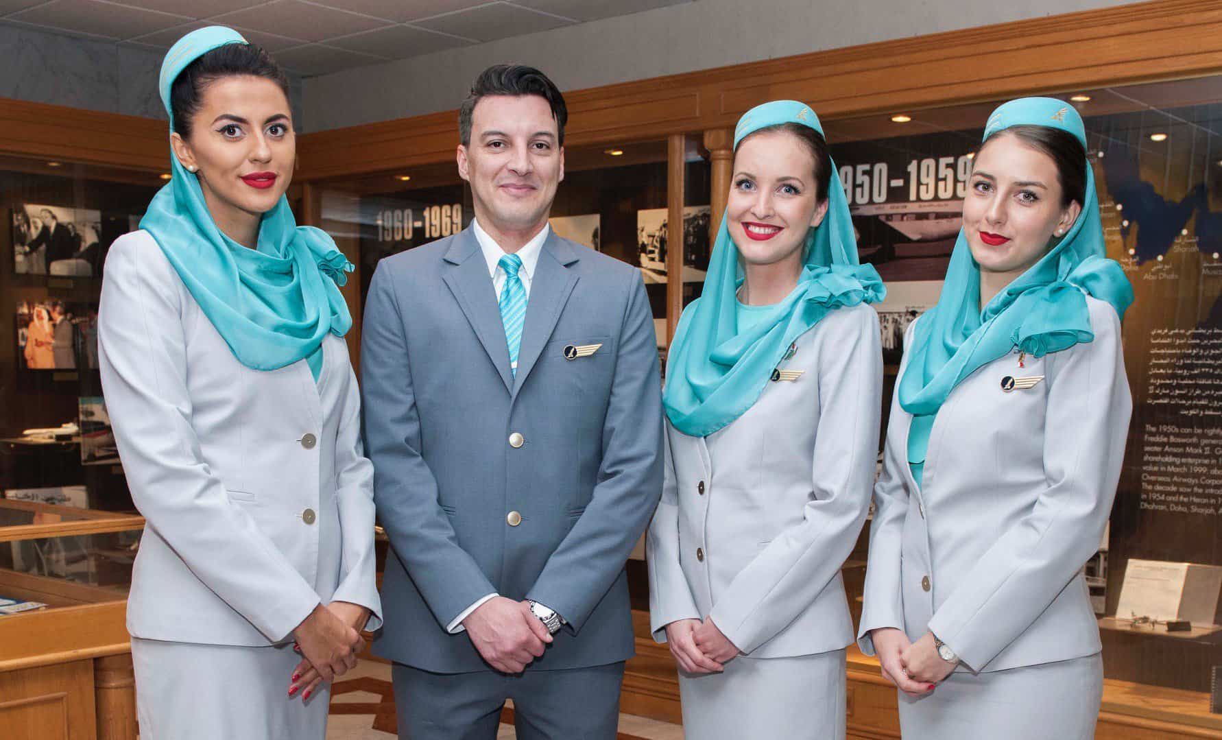 Four Gulf AIr cabin crew members standing in a room.