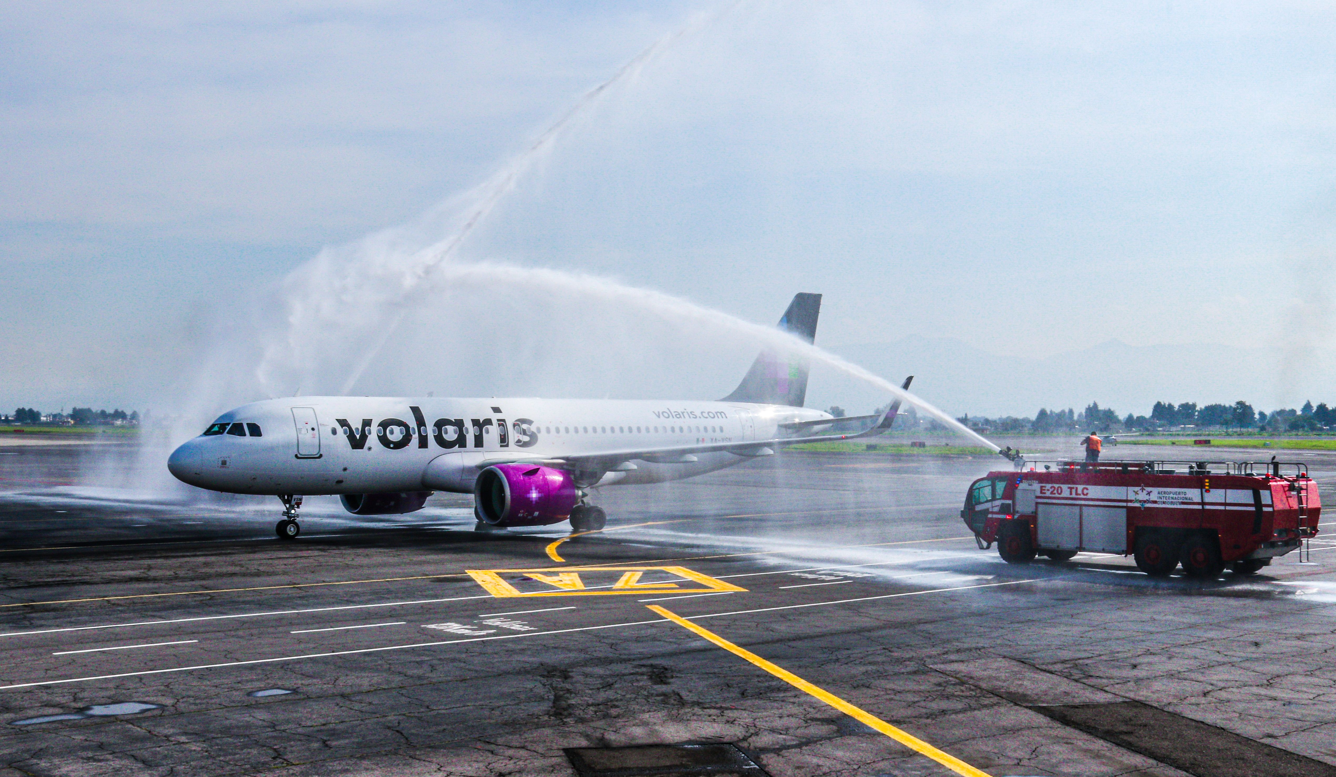 A Volaris aircraft receiving a water cannon salute at Toluca International Airport. 