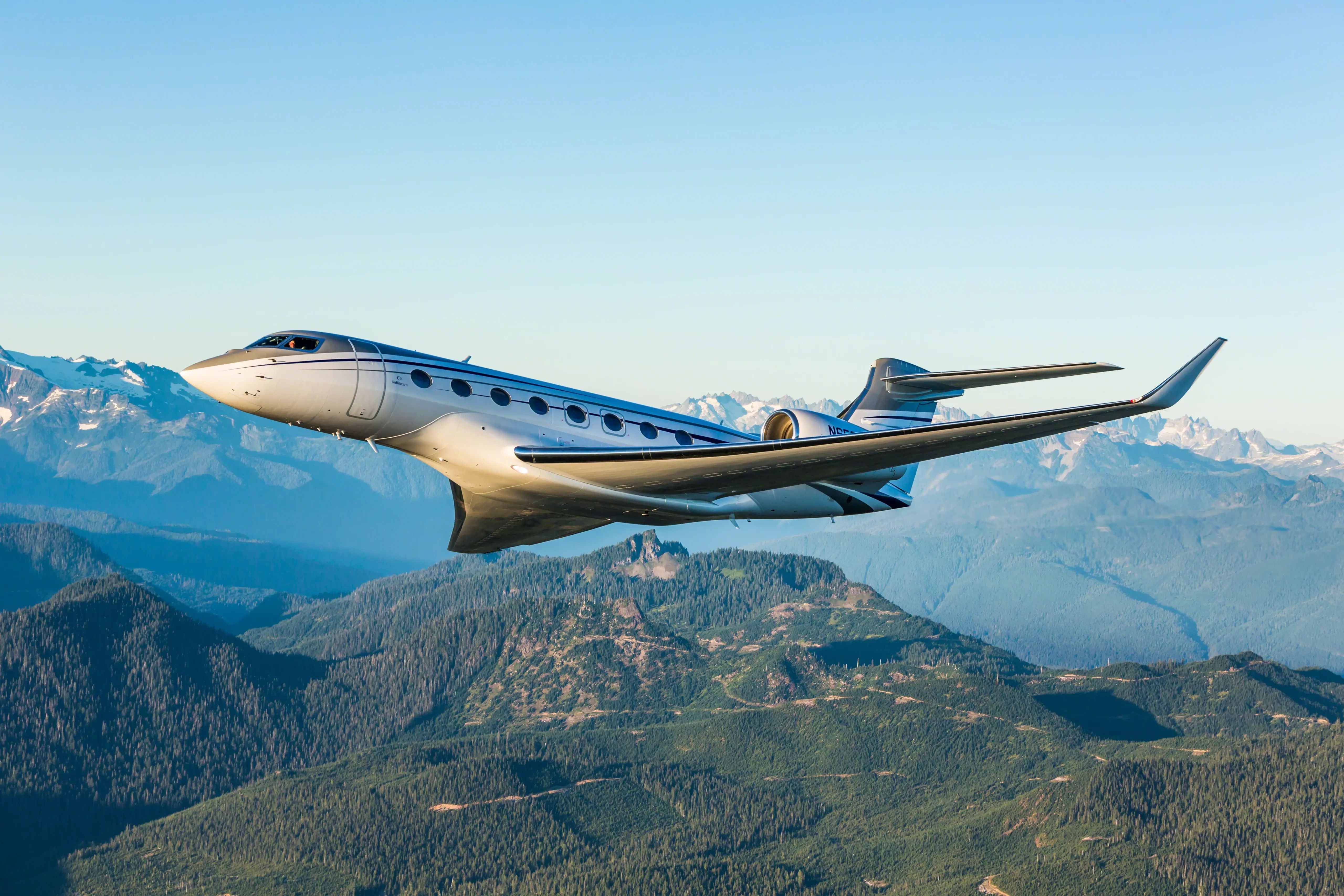 Gulfstream G650 in the air against mountainous backdrop