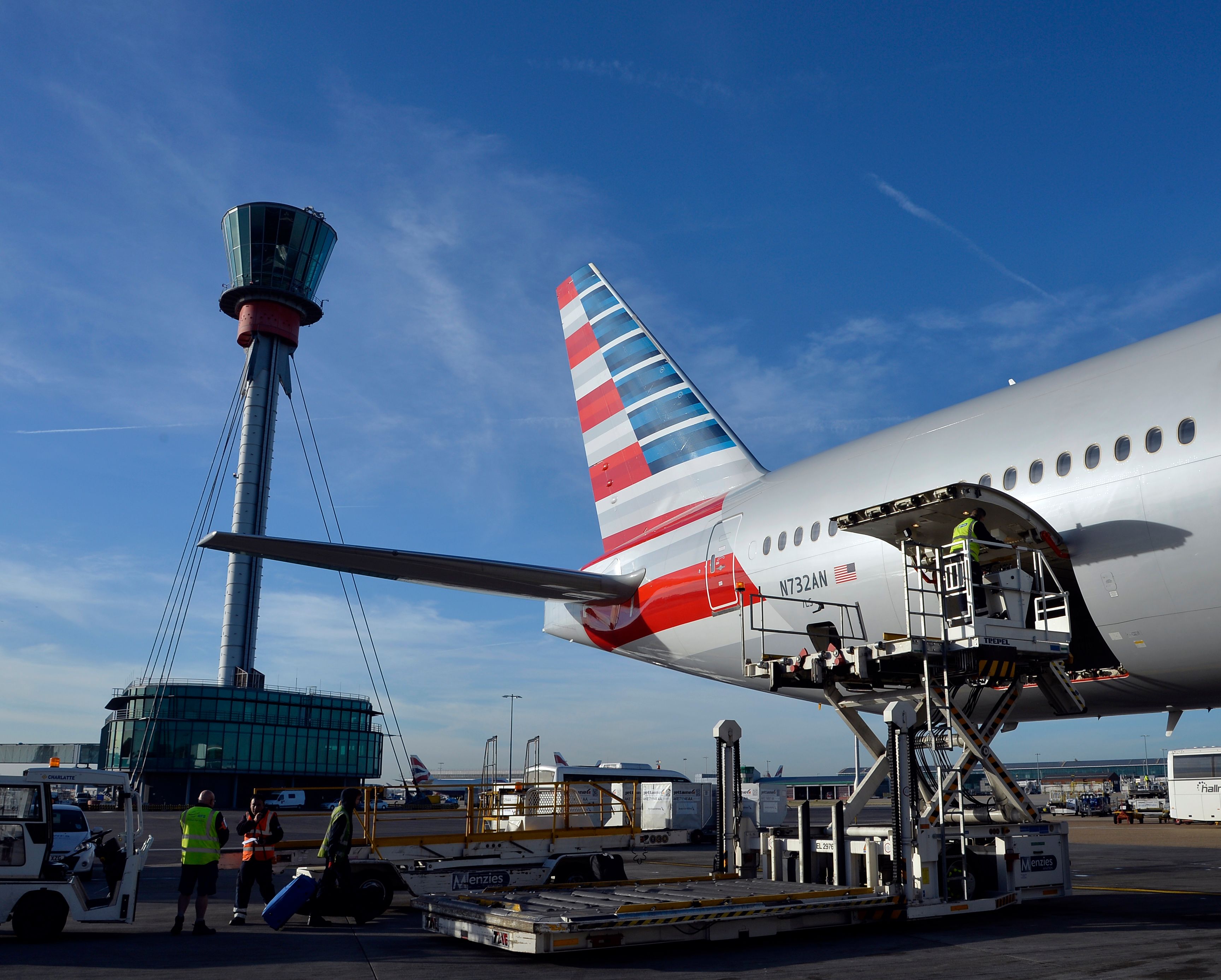 An American Airlines aircraft being loaded with cargo on the apron at London Heathrow Airport.