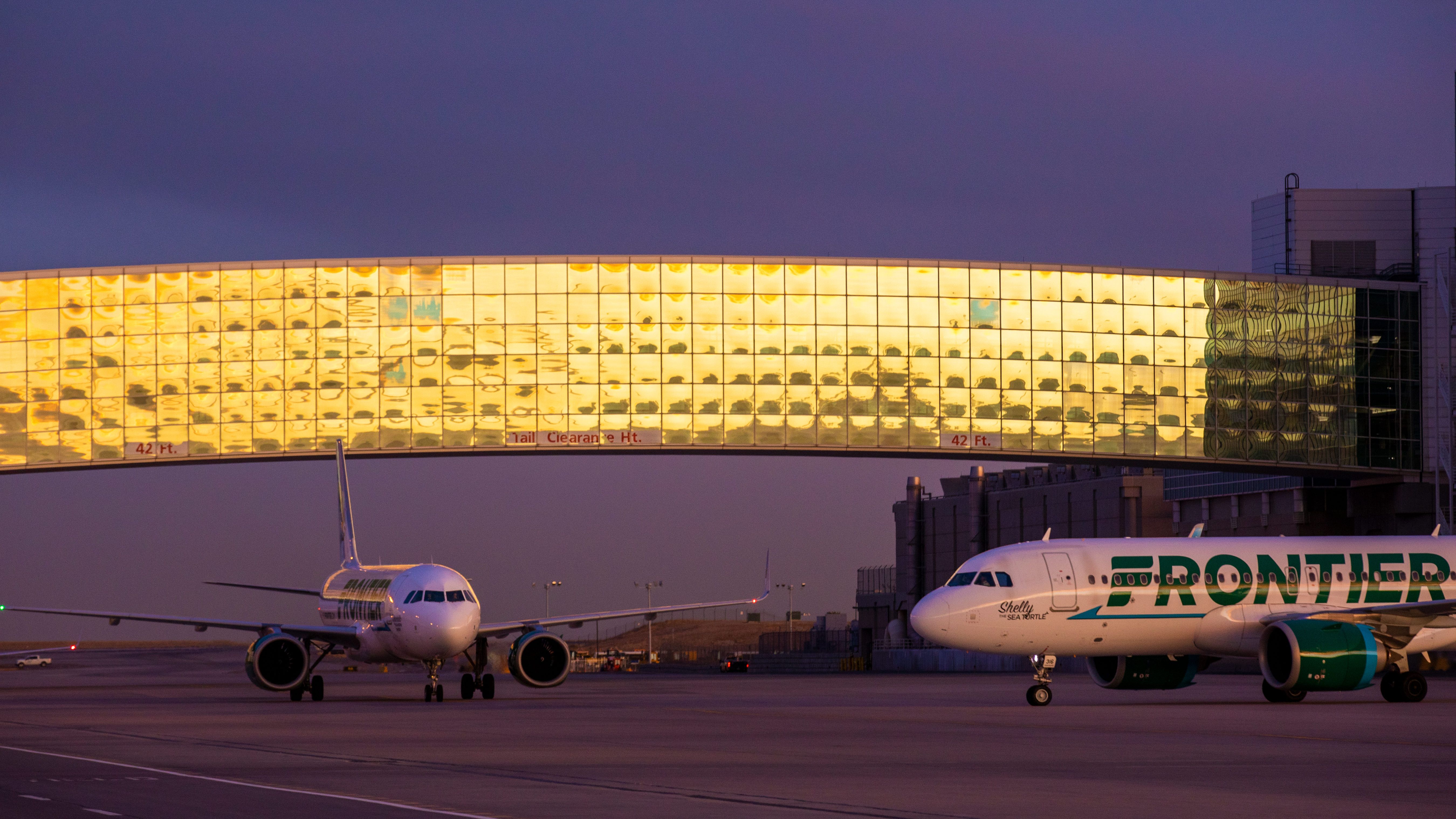 Denver airport at sunset with Frontier aircraft
