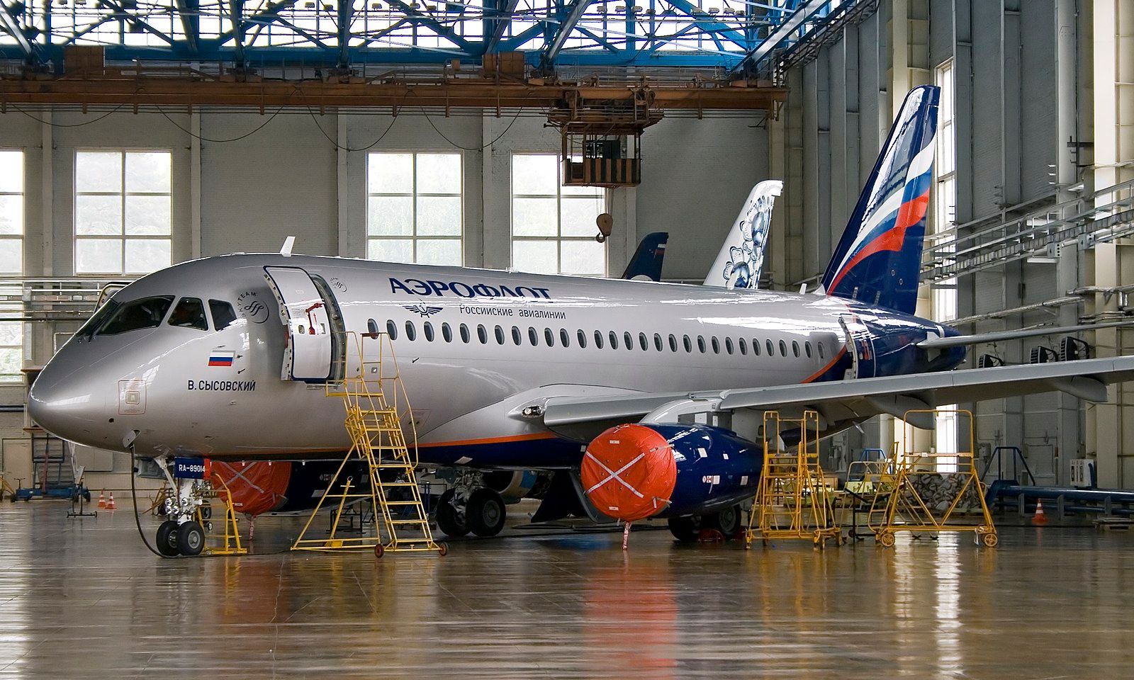 Sukhoi Superjet in hangar with engines covered