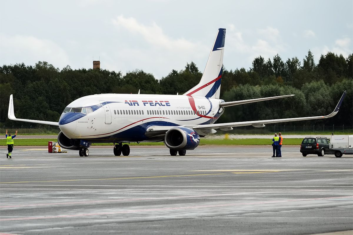 Air Peace Boeing 737 on the apron with maintenance crew around 