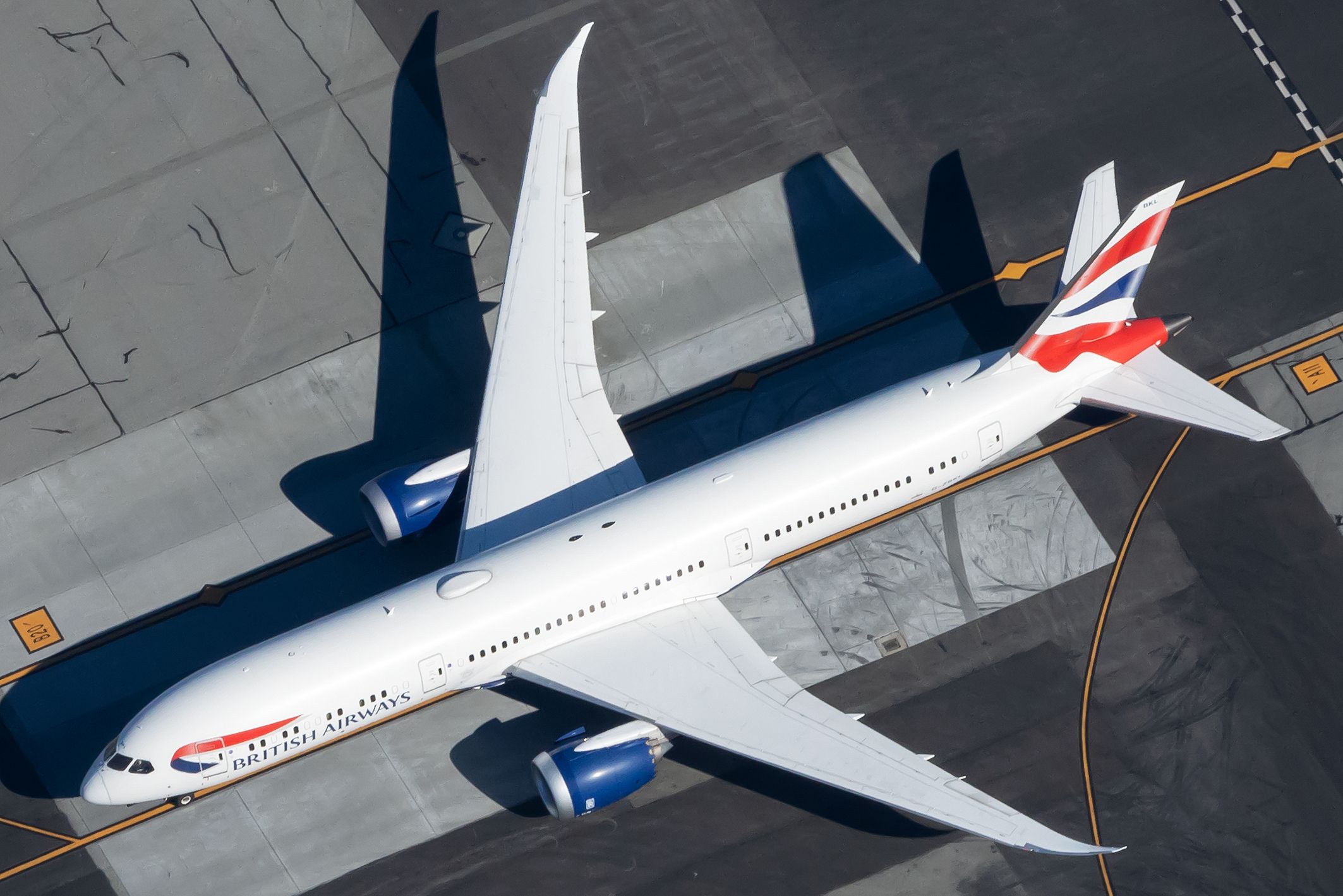 A British Airways Boeing 787-9 Dreamliner on an airport apron.